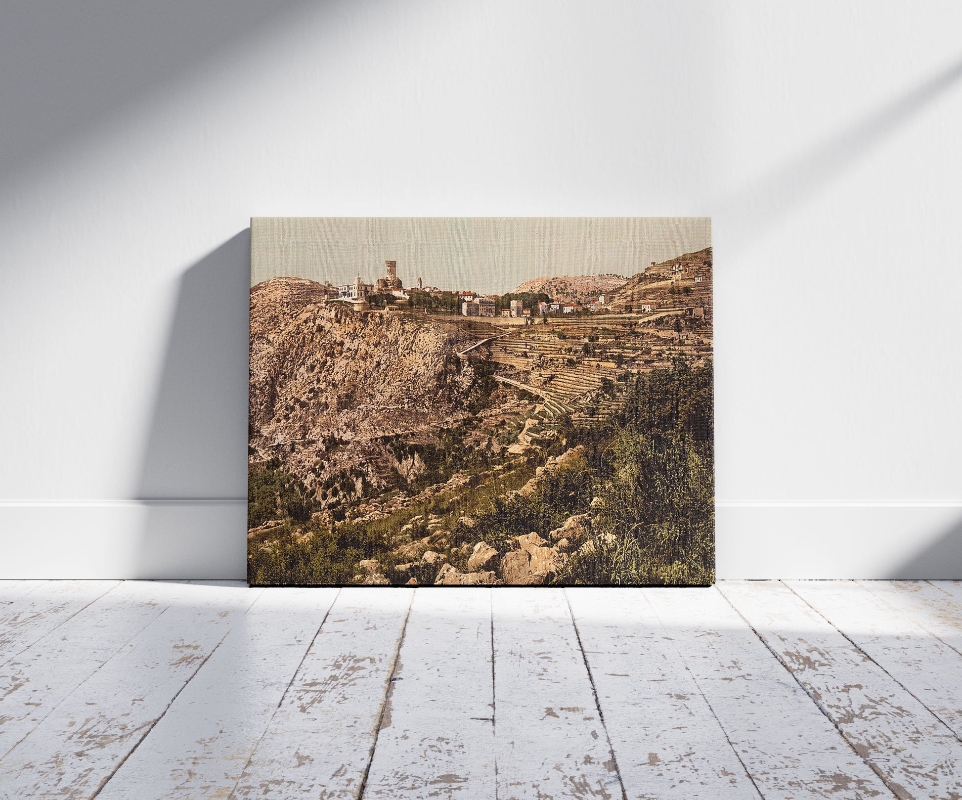 A picture of Station and village, La Turbie, Riviera, a mockup of the print leaning against a wall