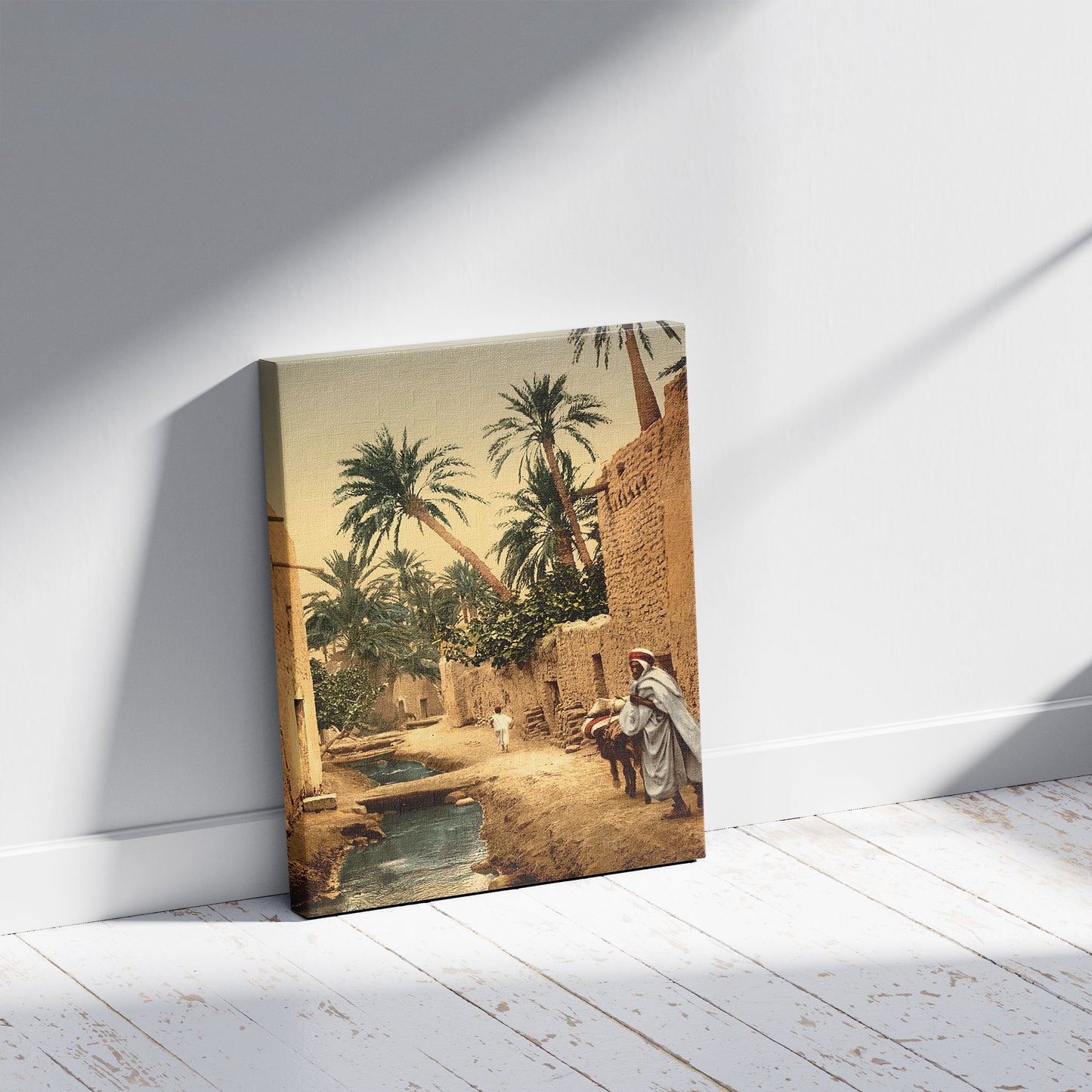A picture of Street in the old town, I, Biskra, Algeria, a mockup of the print leaning against a wall