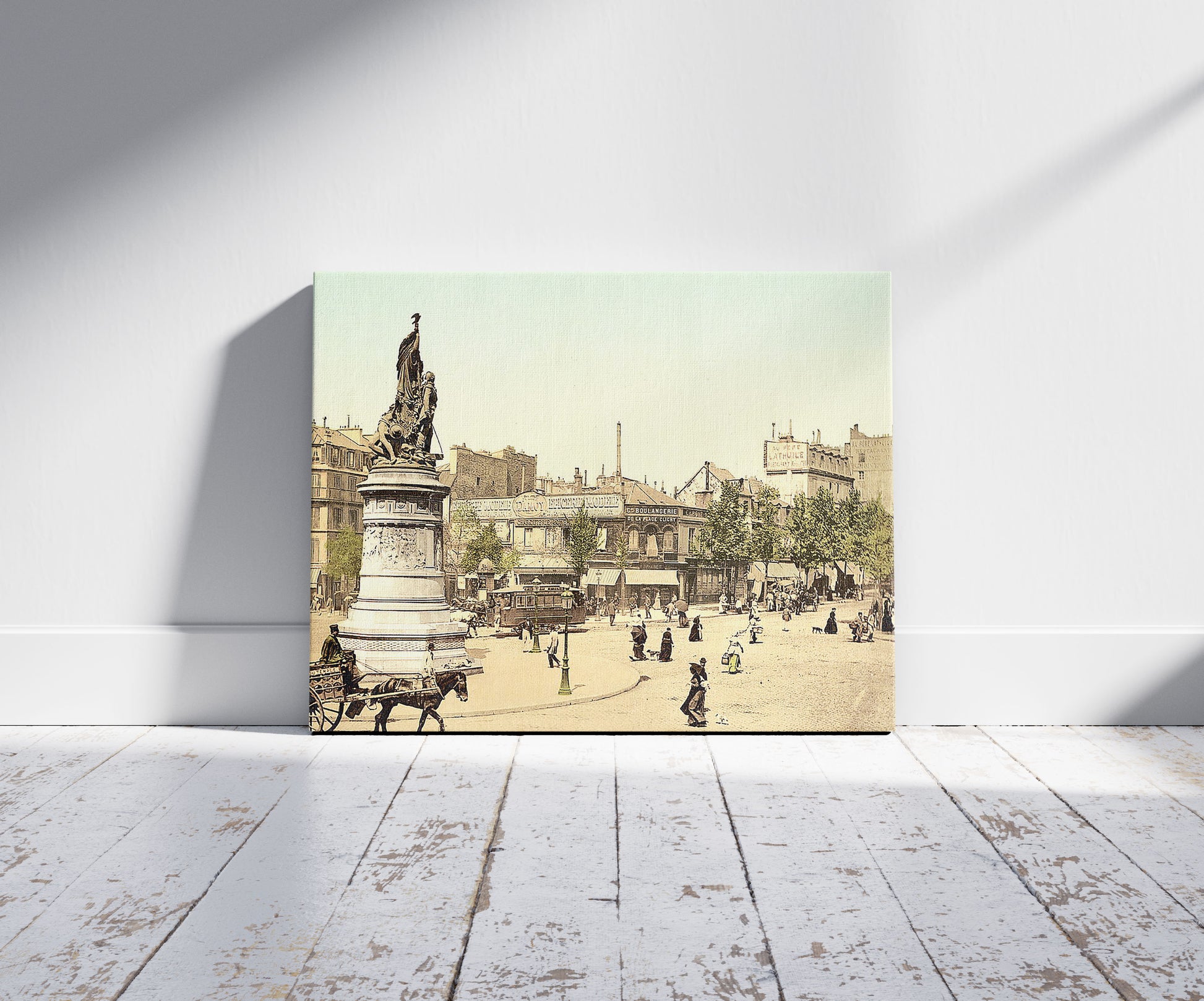 A picture of Street scene and monument, in the Place Clichy, Paris, France, a mockup of the print leaning against a wall