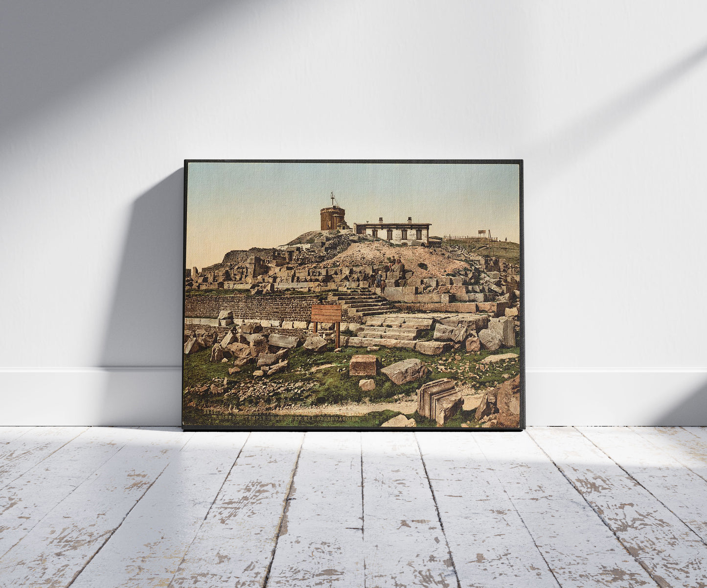 A picture of Summit of the Puy de Dôme and ruins of the temple Mercury, Clermont-Ferrand, France, a mockup of the print leaning against a wall