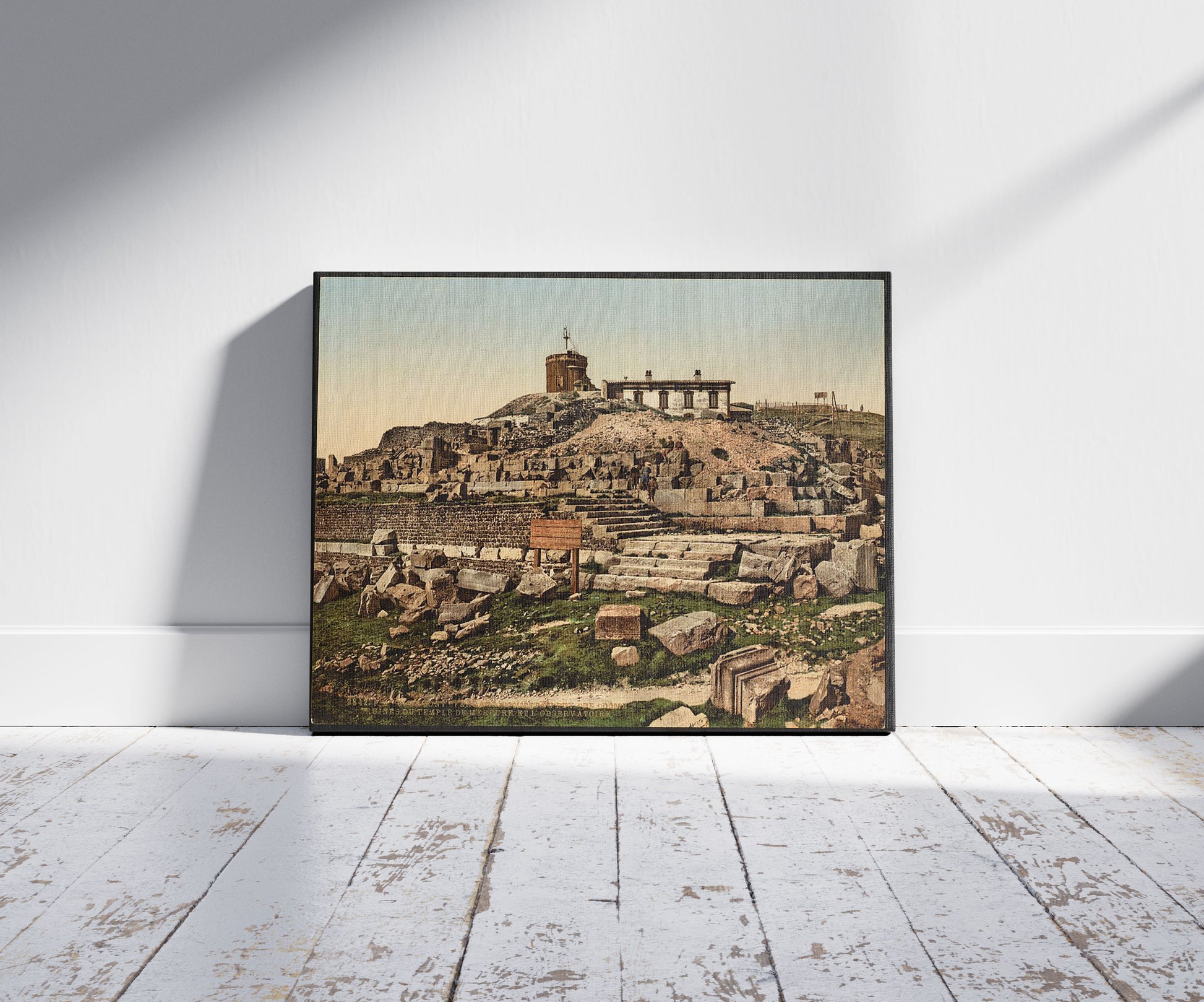 A picture of Summit of the Puy de Dôme and ruins of the temple Mercury, Clermont-Ferrand, France, a mockup of the print leaning against a wall