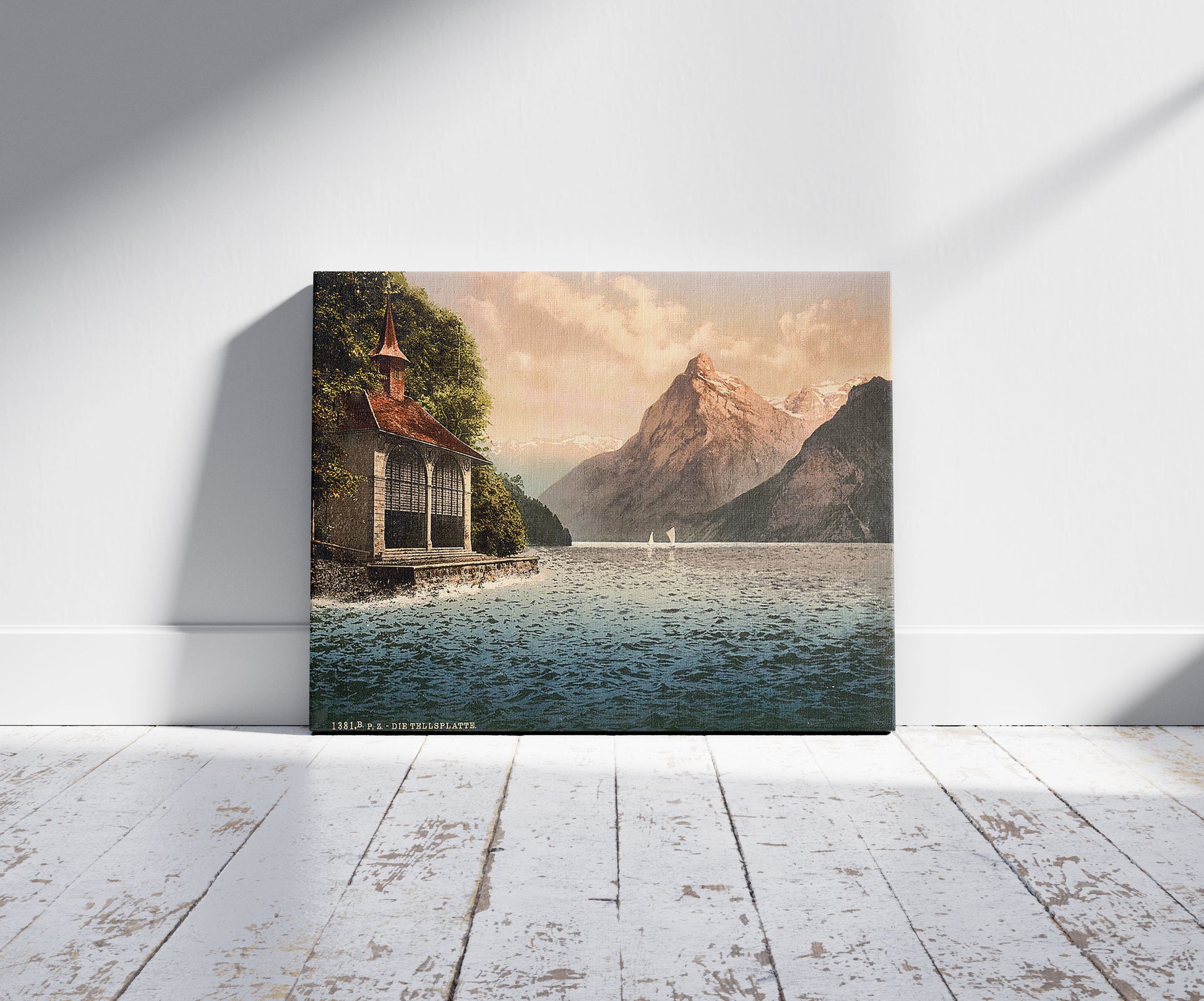 A picture of Tell's Chapel, evening view, Lake Lucerne, Switzerland, a mockup of the print leaning against a wall