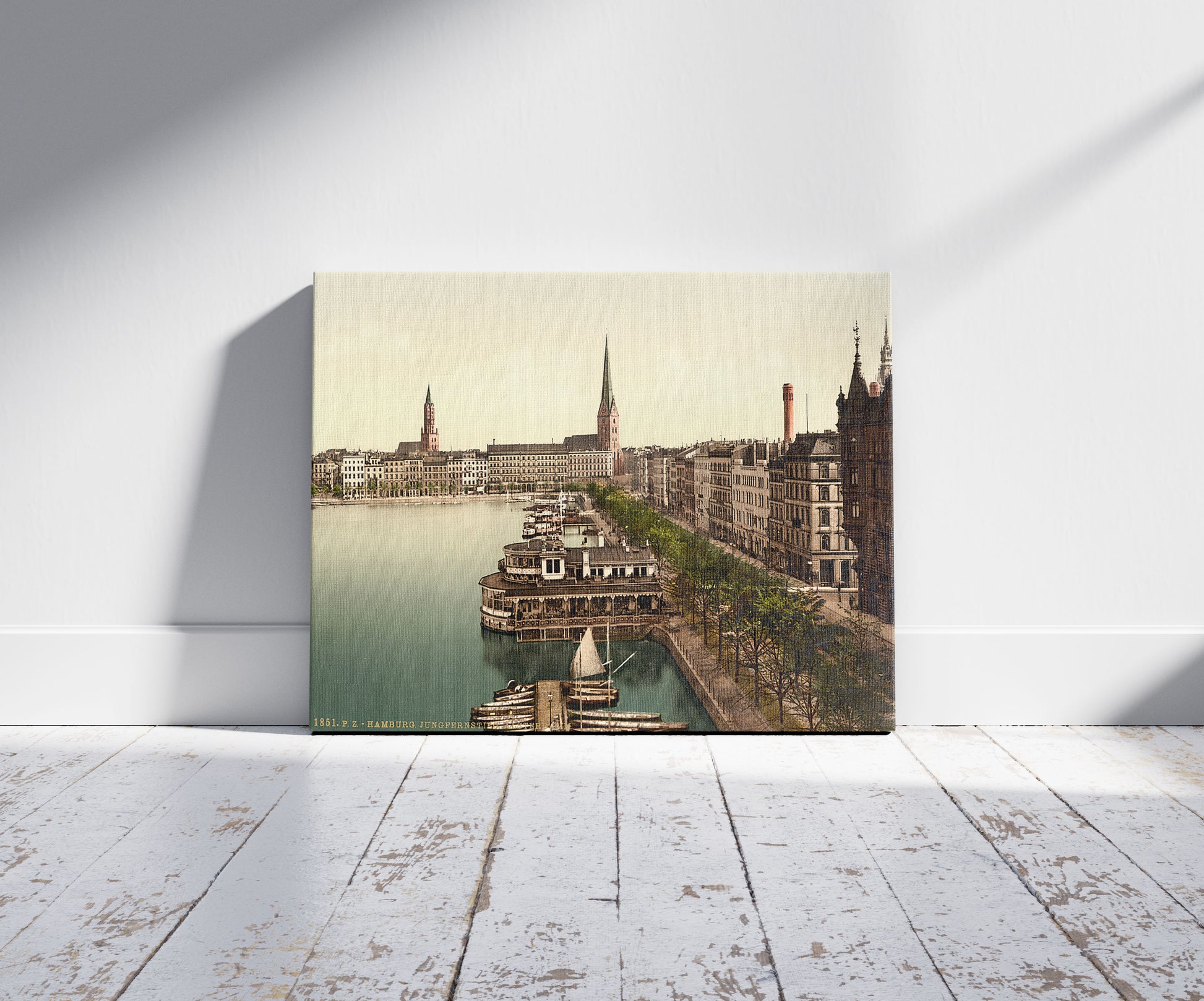 A picture of The Alster Pavillon, Junfernsteig, Hamburg, Germany, a mockup of the print leaning against a wall