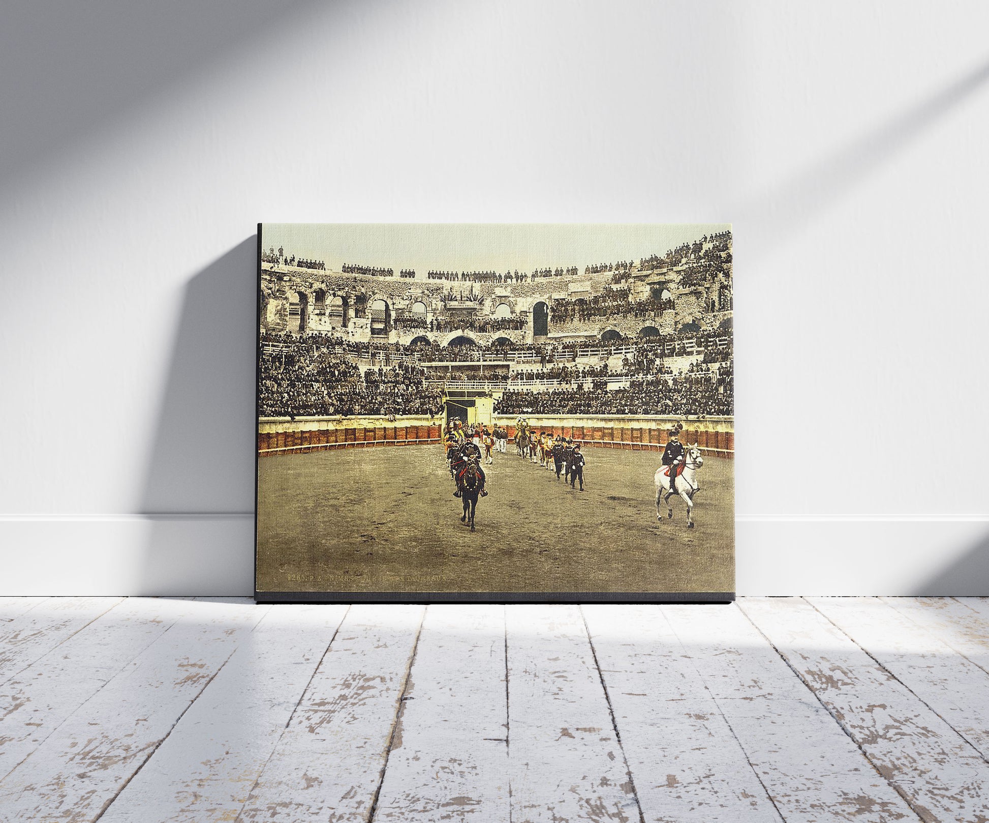 A picture of The arena, bull ring, Nîmes, France, a mockup of the print leaning against a wall