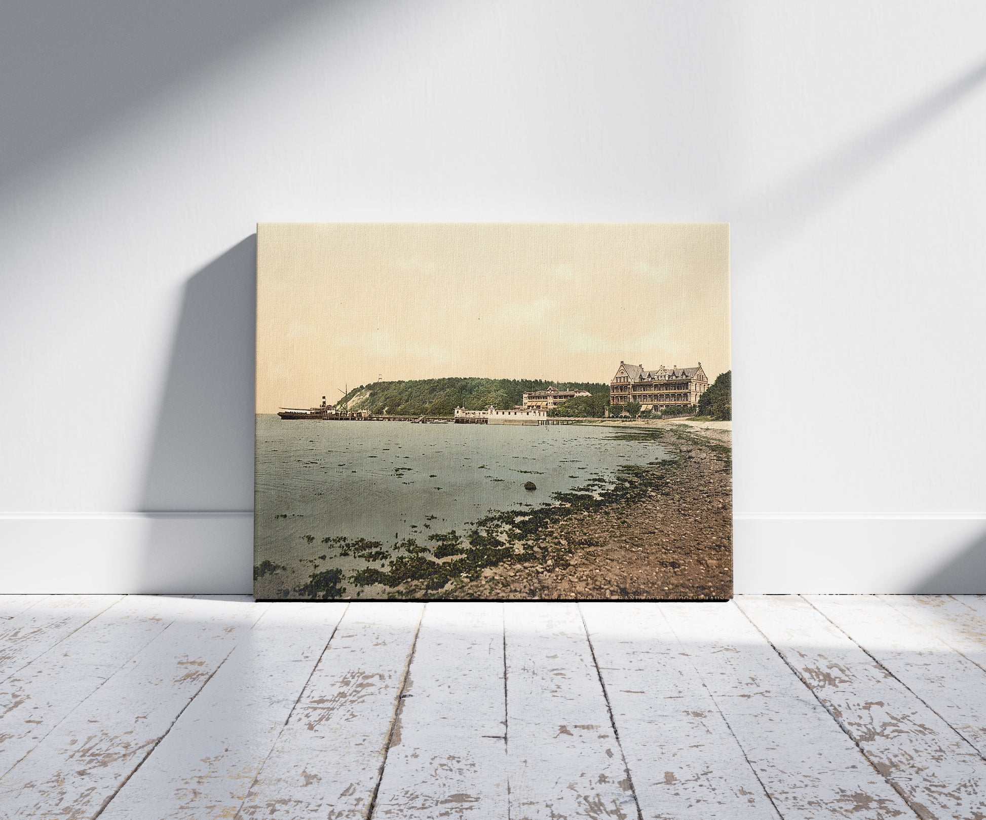 A picture of The beach and hotel, Glucksburg, Schleswig-Holstein, Germany, a mockup of the print leaning against a wall