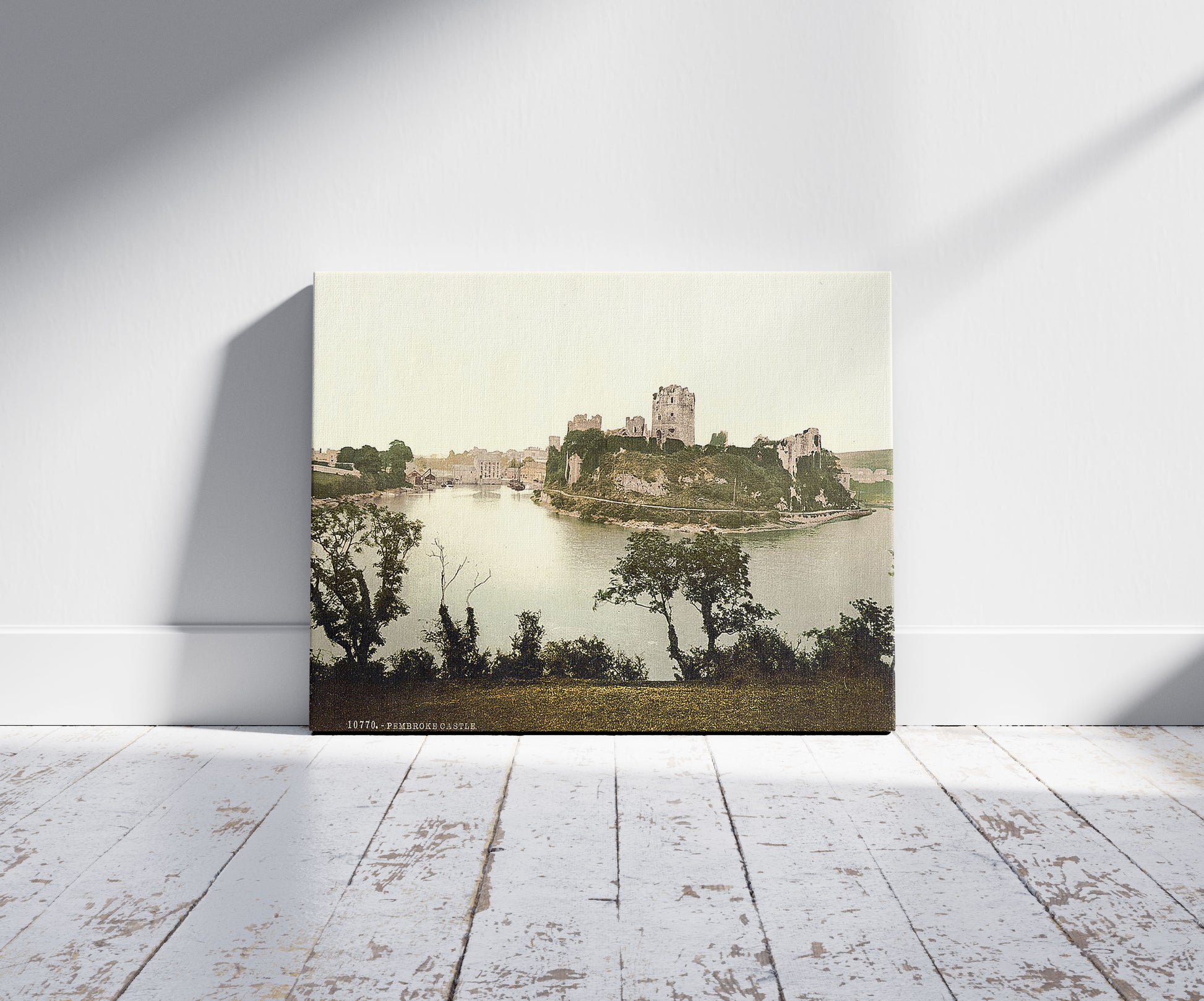 A picture of The castle, Pembroke, Wales, a mockup of the print leaning against a wall
