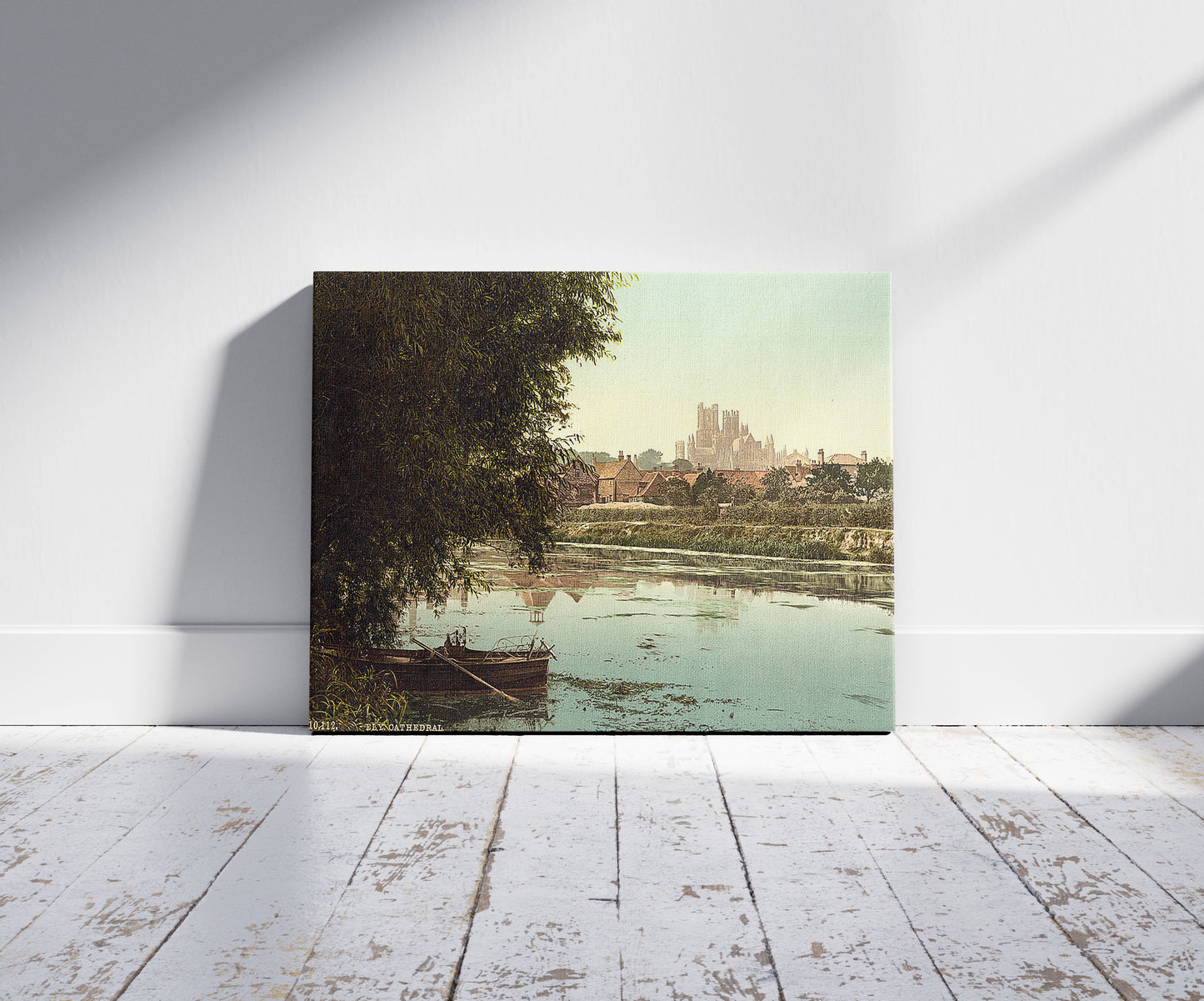 A picture of The cathedral from the river, Ely, England, a mockup of the print leaning against a wall