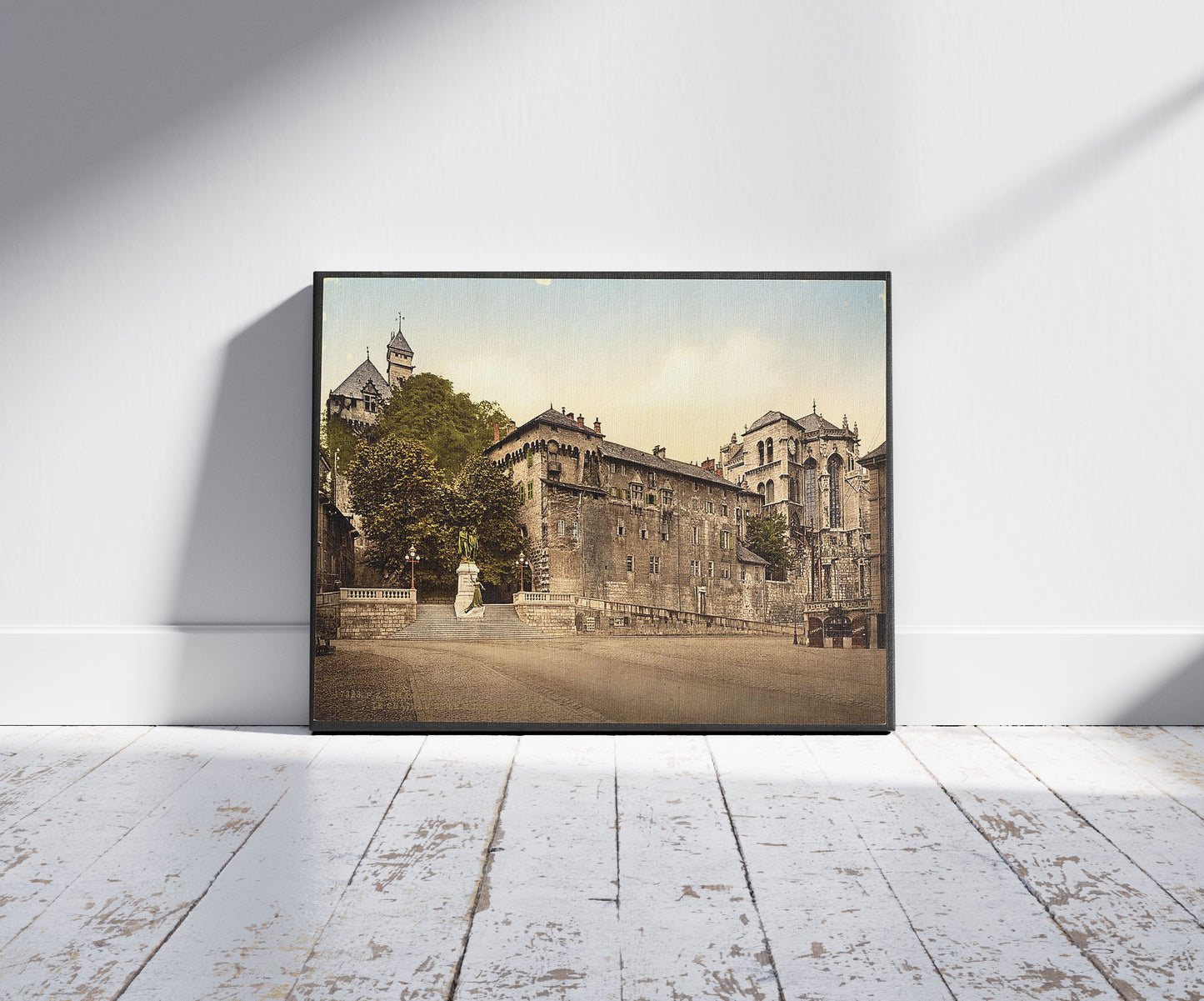 A picture of The Chateau and the monument Maistre, Chambéry, France, a mockup of the print leaning against a wall