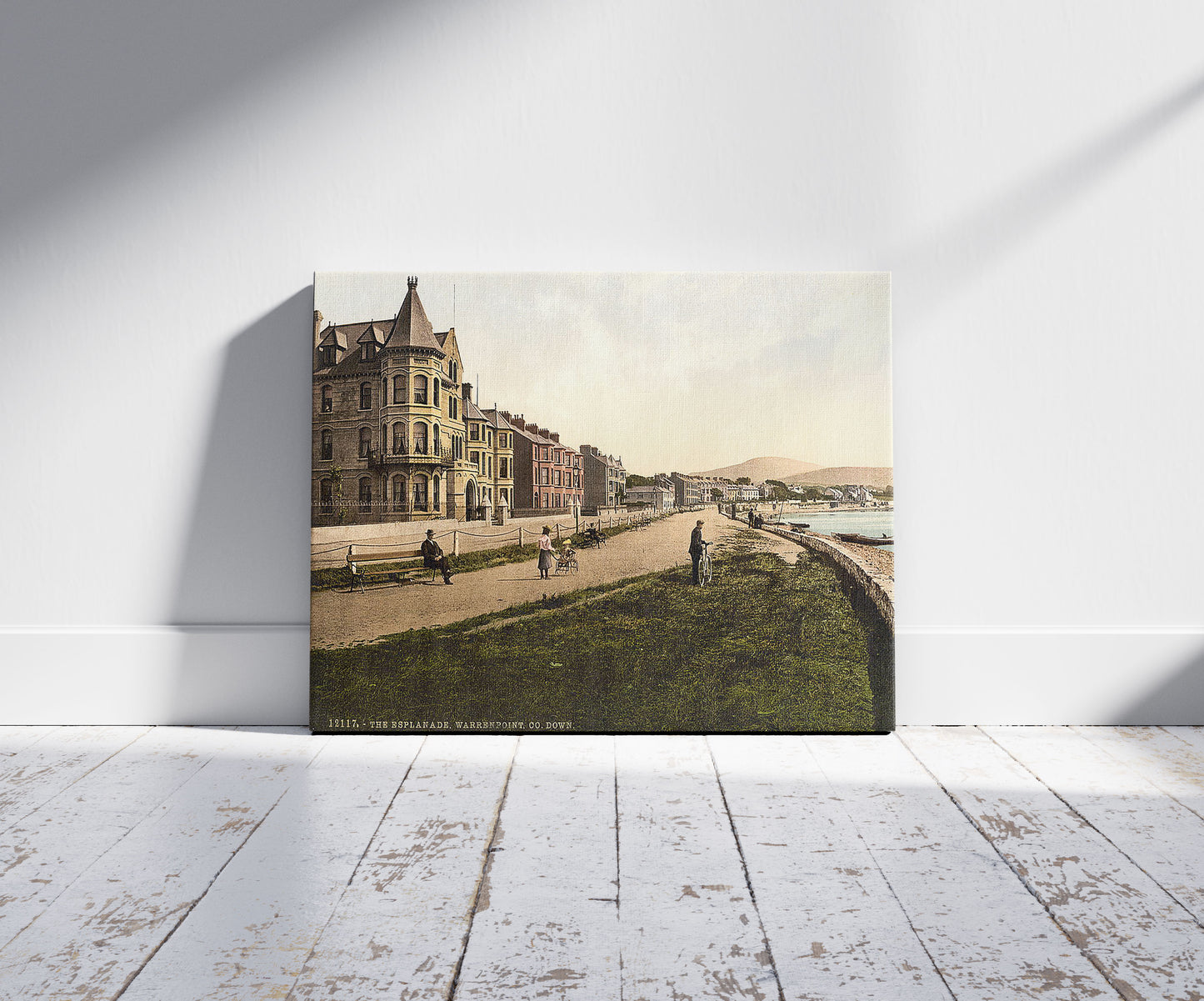 A picture of The Esplanade, Warrenpoint. County Down, Ireland, a mockup of the print leaning against a wall