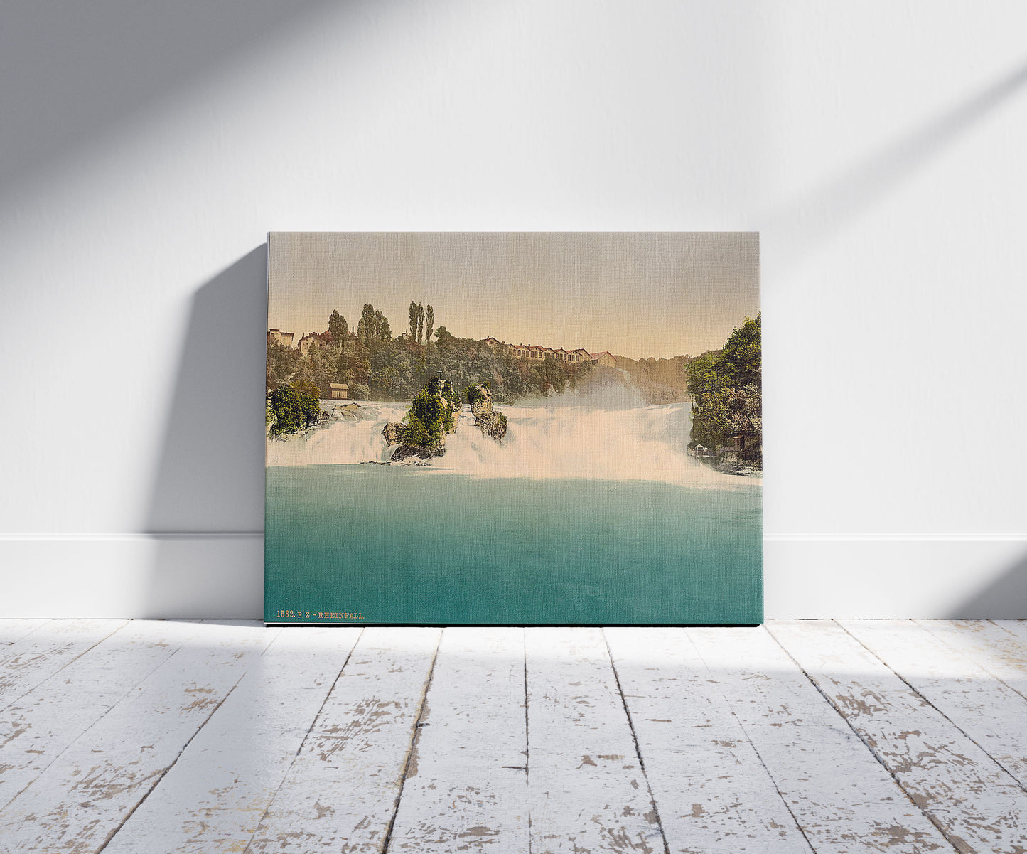 A picture of The Falls of the Rhine, from the Schlossli, Schaffhausen, Switzerland, a mockup of the print leaning against a wall