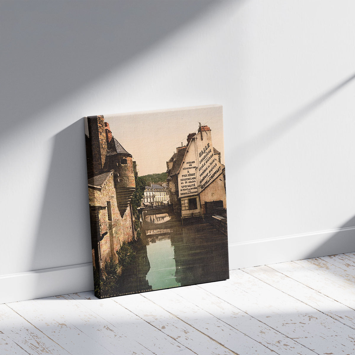 A picture of The footbridge of the Steir, Quimper, France, a mockup of the print leaning against a wall