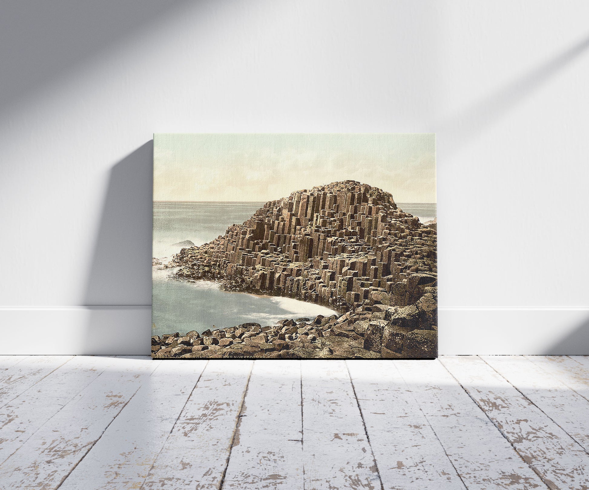 A picture of The Honeycombs, Giant's Causeway. County Antrim, Ireland, a mockup of the print leaning against a wall