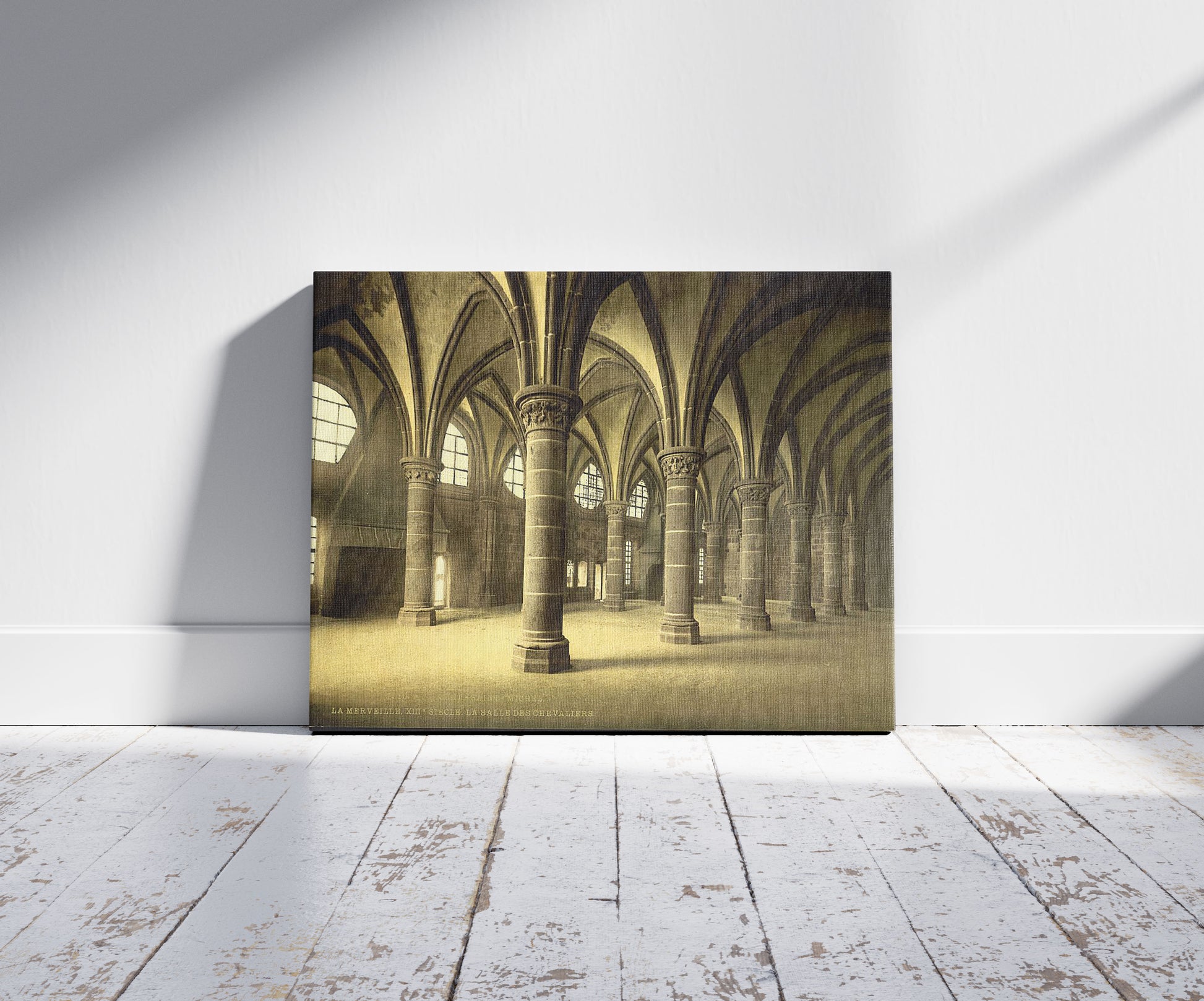 A picture of The knights' hall, Mont St. Michel, France, a mockup of the print leaning against a wall