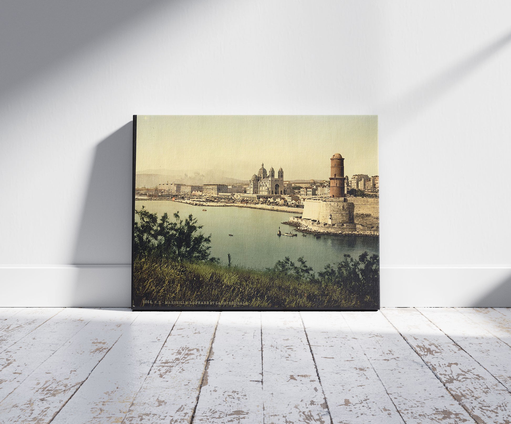 A picture of The lighthouse and cathedral, Marseilles, France, a mockup of the print leaning against a wall