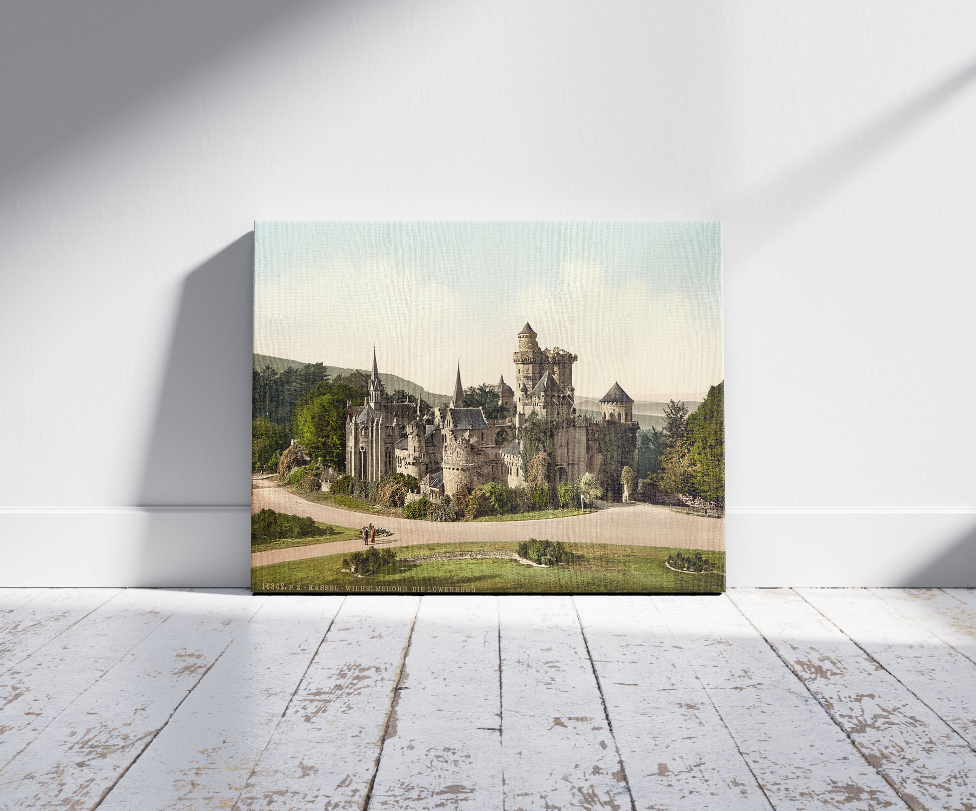 A picture of The Lower Castle (i.e., Lions Castle), Wilhelmshohe, Cassel (i.e., Kassel), Hesse-Nassau, Germany, a mockup of the print leaning against a wall