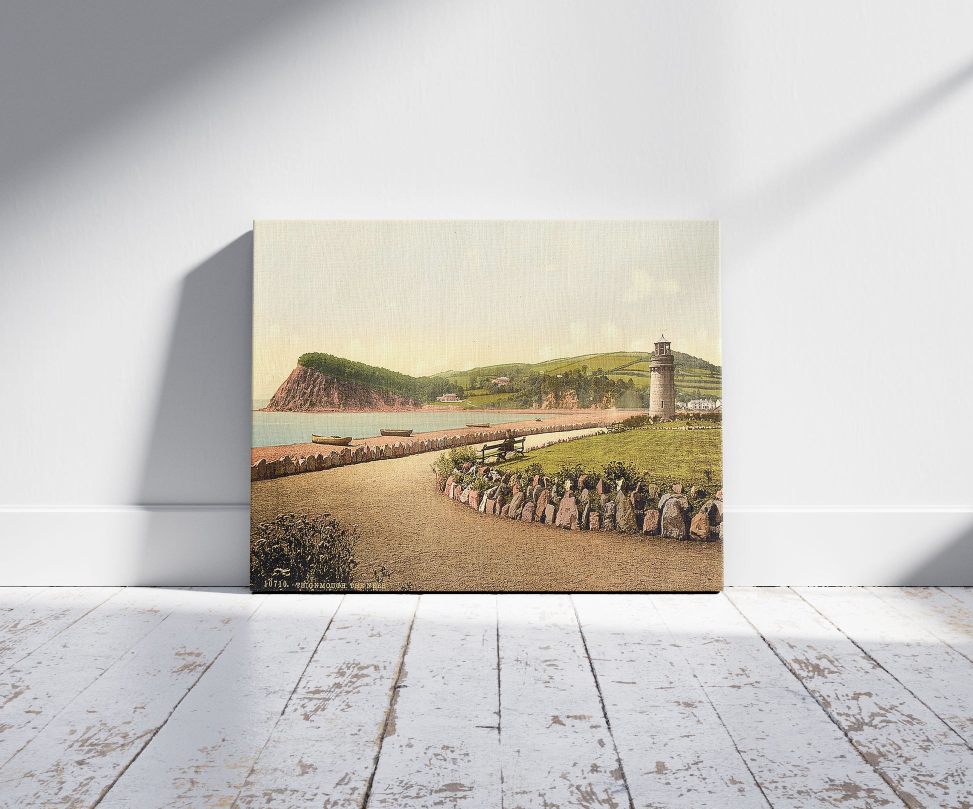 A picture of The Ness, Teignmouth, England, a mockup of the print leaning against a wall