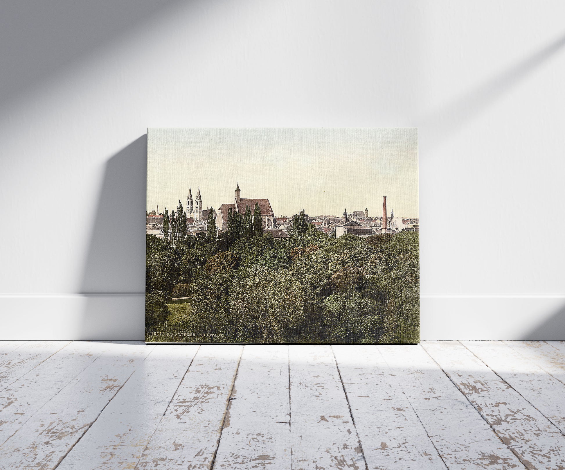 A picture of The new city, Vienna, Austro-Hungary, a mockup of the print leaning against a wall
