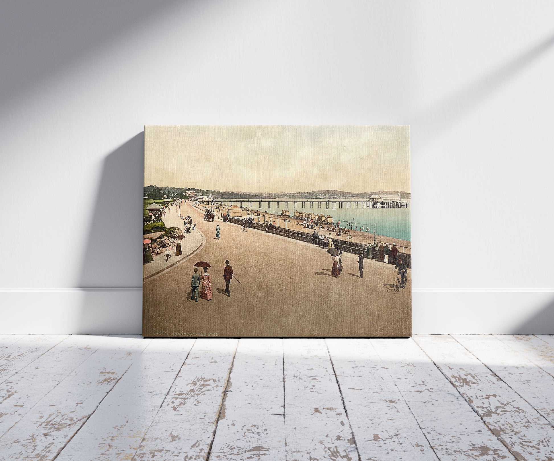 A picture of The pier, Paignton, England, a mockup of the print leaning against a wall