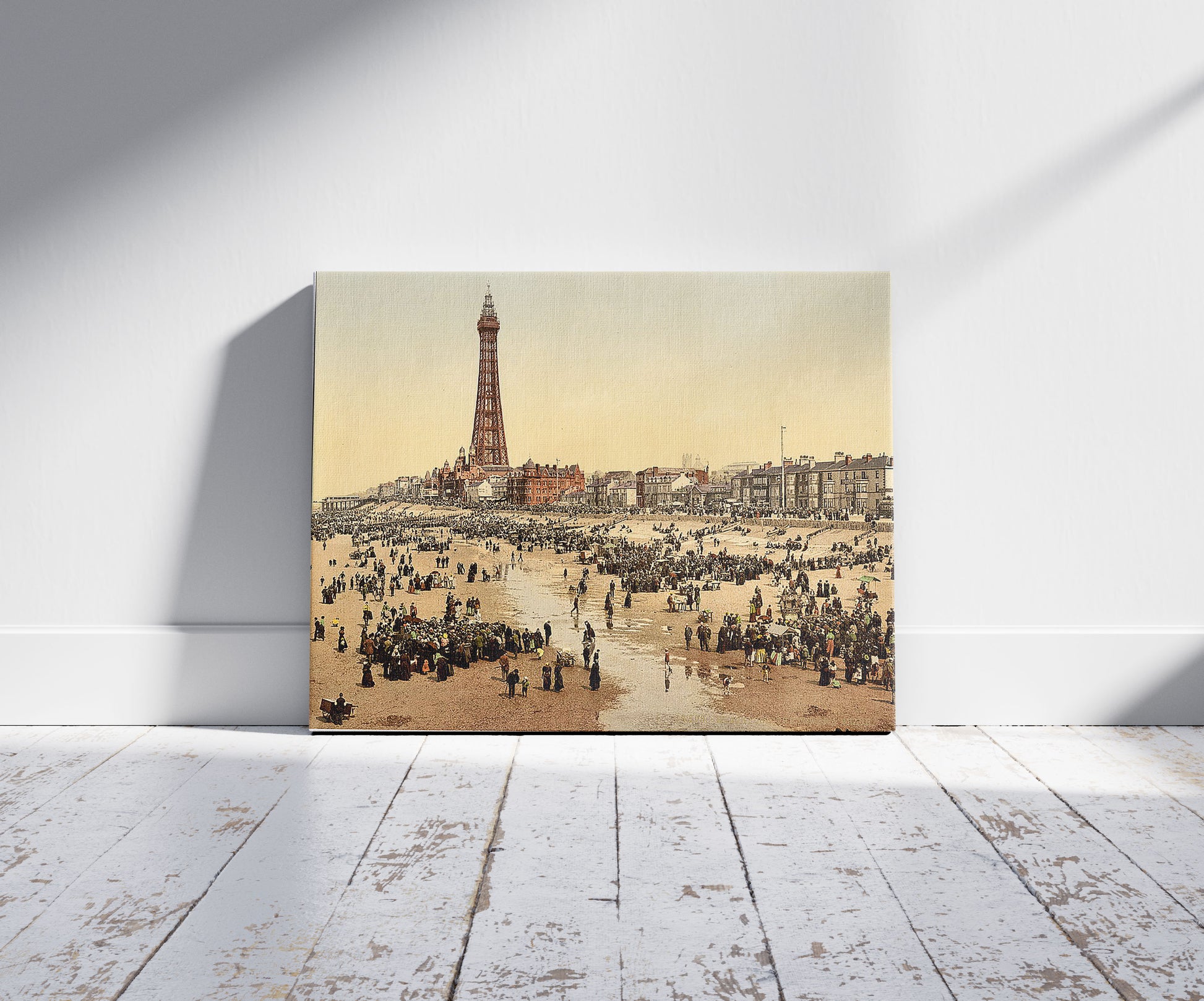 A picture of The Promenade and Tower from South Pier, Blackpool, England, a mockup of the print leaning against a wall