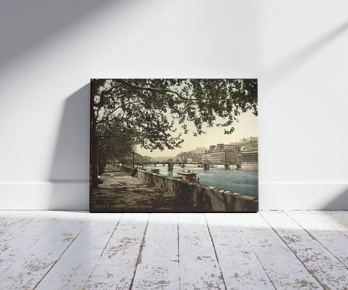 A picture of The quay of the Saône, Lyons, France, a mockup of the print leaning against a wall