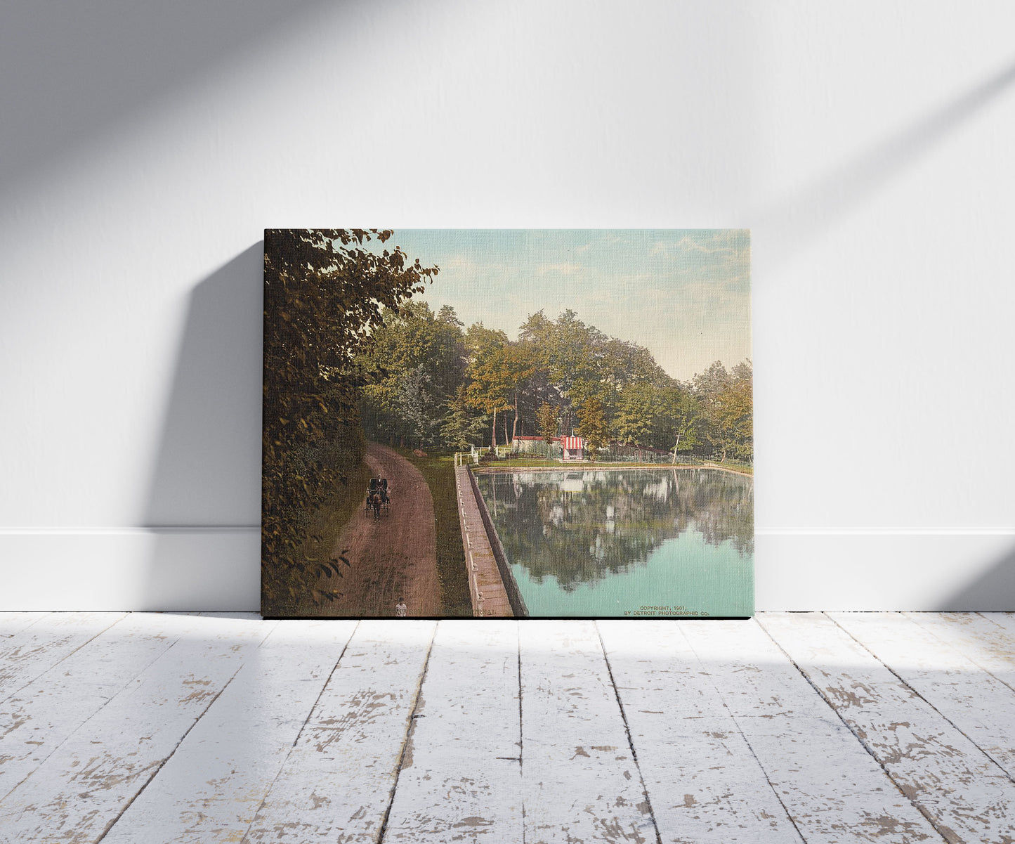 A picture of The Reservoir, Mount Royal Park, Montreal, a mockup of the print leaning against a wall