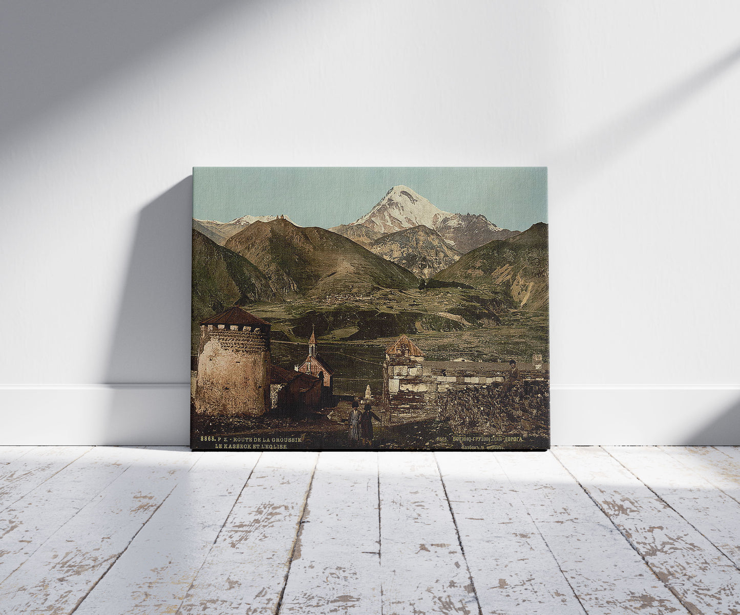 A picture of The road, the kasbeck and the church, Groussie, Georgia, a mockup of the print leaning against a wall