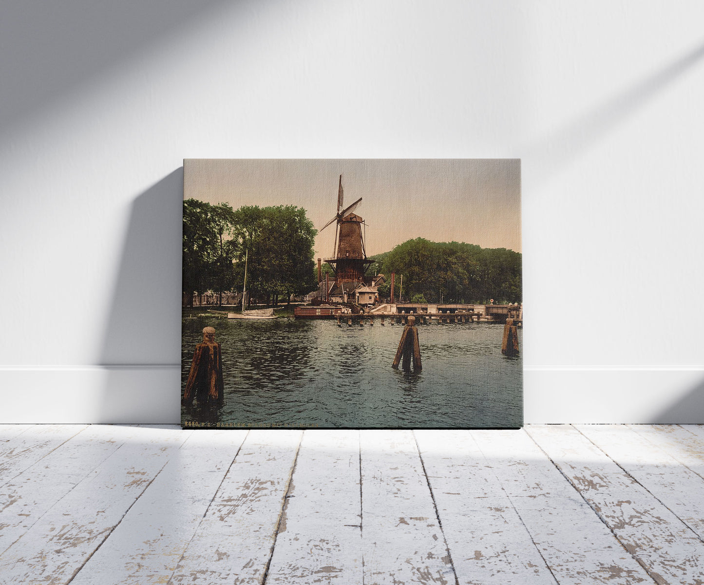 A picture of The Spaarne and windmill, Haarlem, Holland, a mockup of the print leaning against a wall