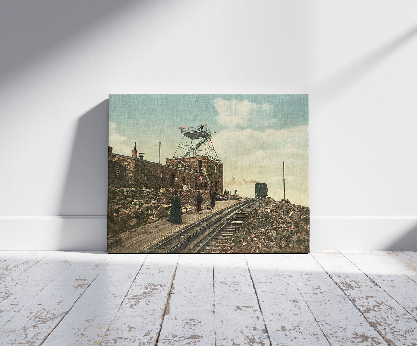 A picture of The summit of Pike's Peak, a mockup of the print leaning against a wall