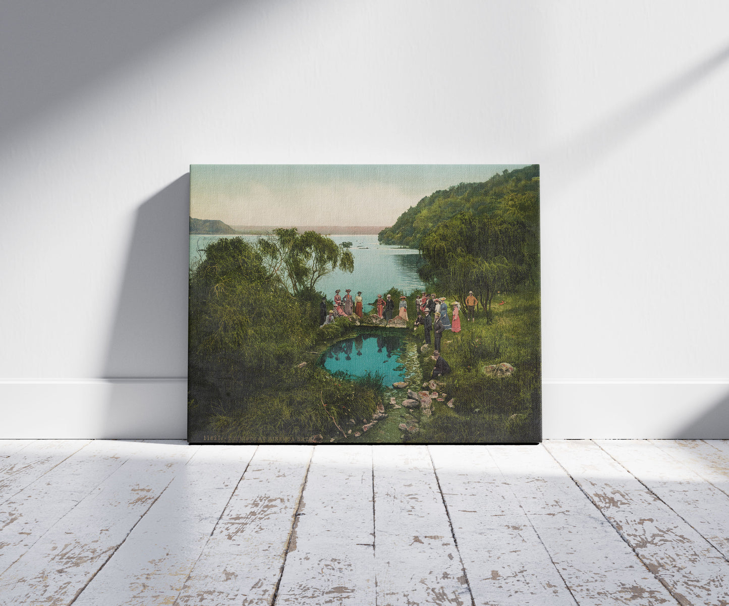 A picture of Tourists at Hinemoa Bath. Mokoia Island, Rotorua, a mockup of the print leaning against a wall