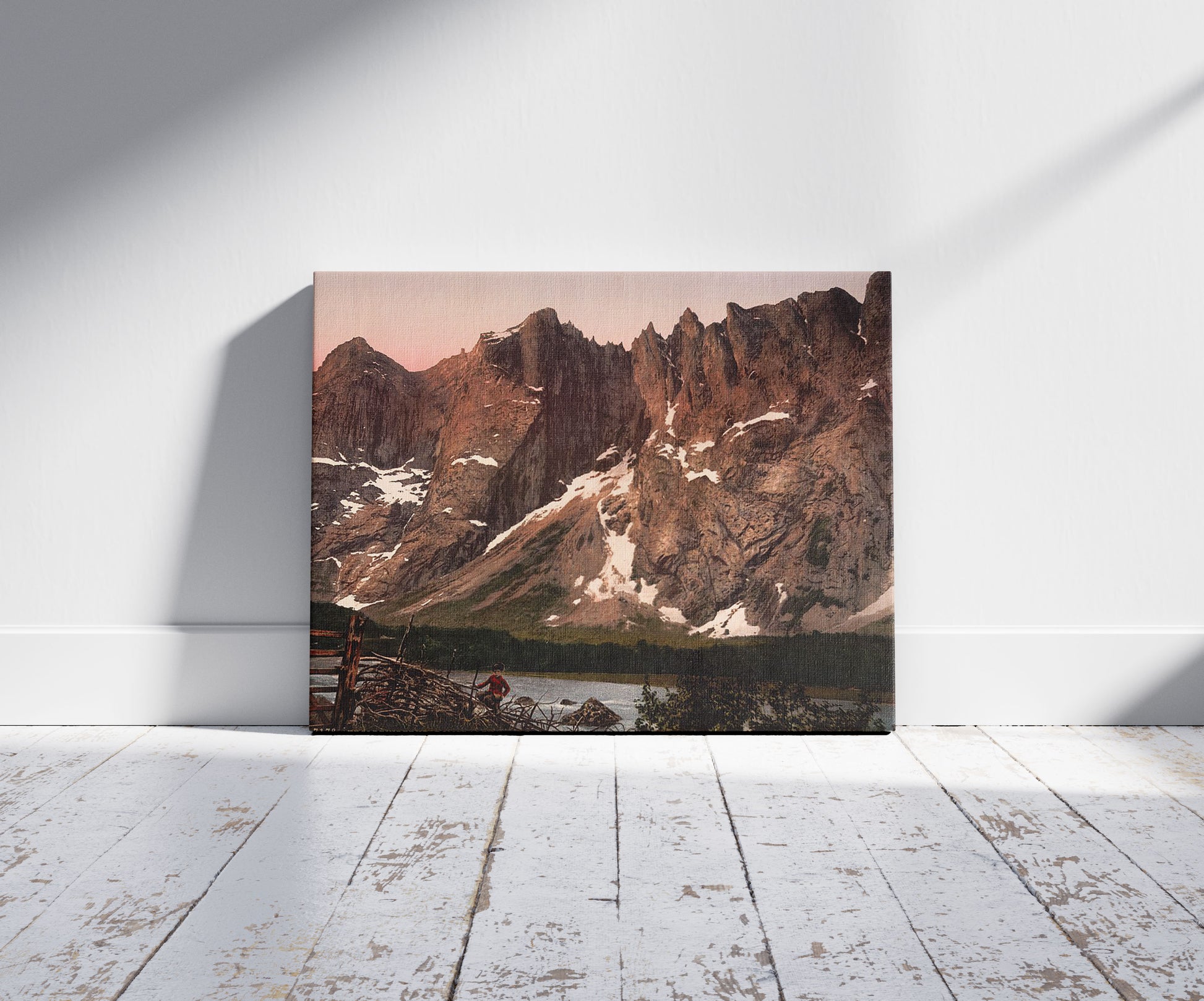 A picture of Troldtinderne (i.e., Trolltindene), Romsdalen, Norway, a mockup of the print leaning against a wall