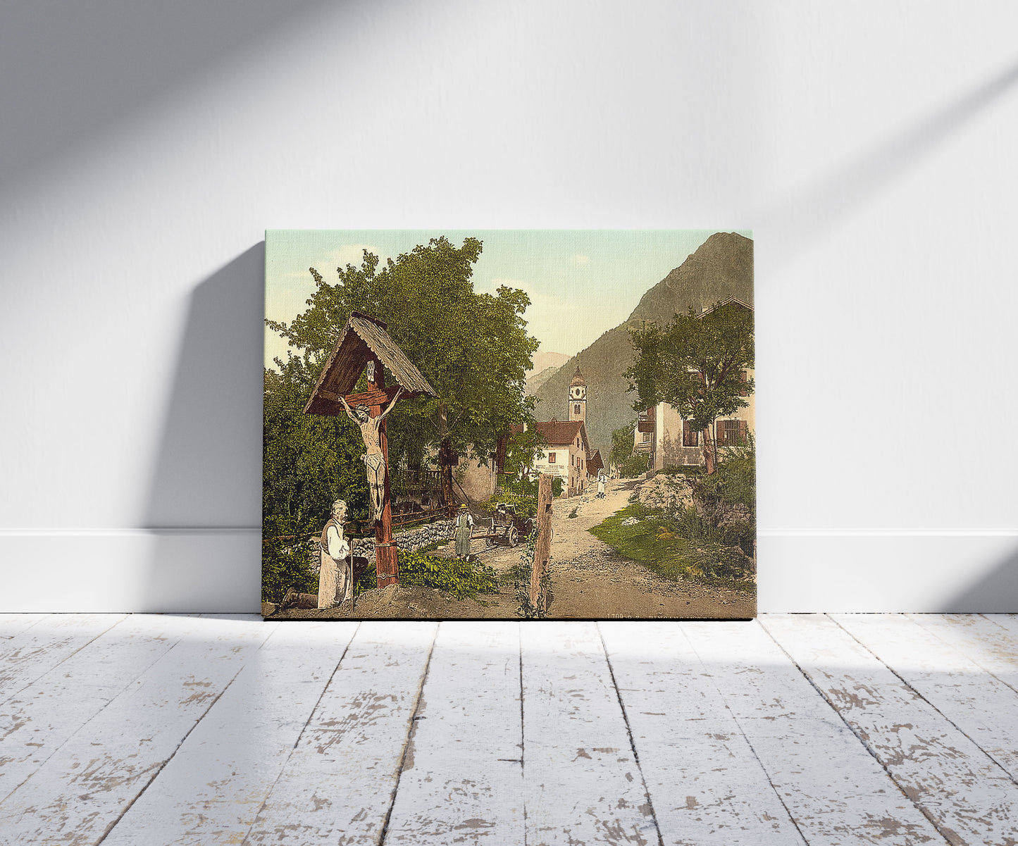 A picture of Tyrol Village ("Village with crucifix"), Tyrol, Austro-Hungary, a mockup of the print leaning against a wall