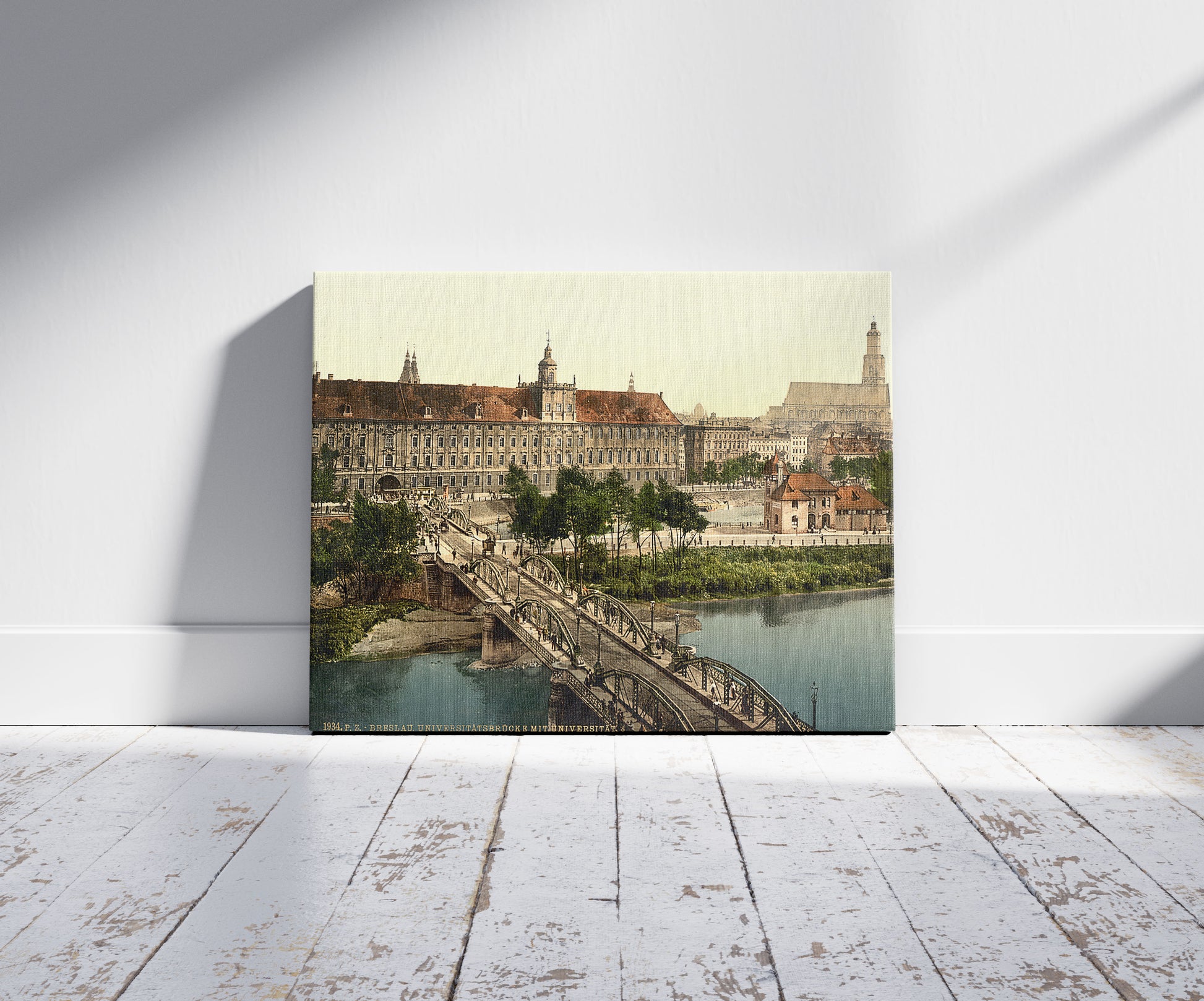 A picture of University with bridge, Breslau, Silesia, Germany (i.e., Wrocław, Poland), a mockup of the print leaning against a wall