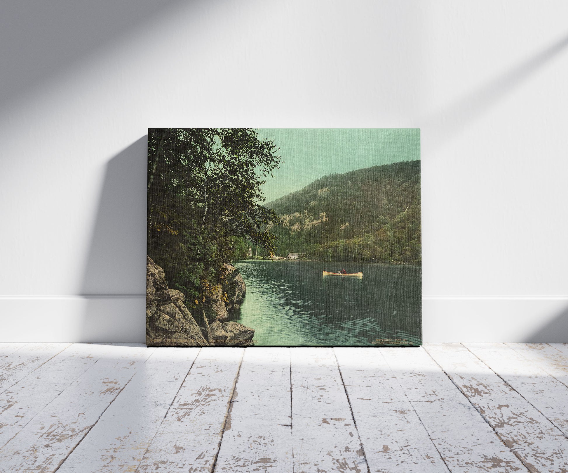 A picture of Upper Cascade Lake, Adirondack Mountains, a mockup of the print leaning against a wall