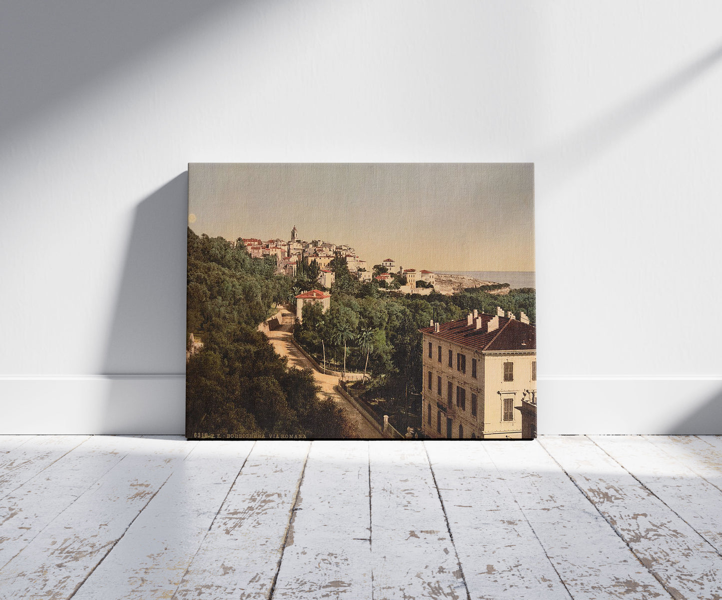 A picture of Via Romana, Bordighera, Riviera, a mockup of the print leaning against a wall