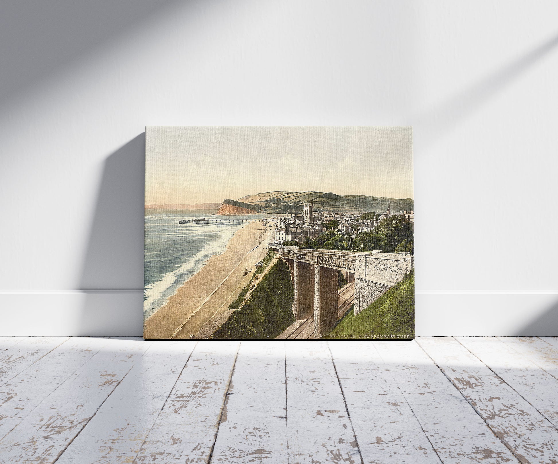 A picture of View from E. Cliff, Teignmouth, England, a mockup of the print leaning against a wall