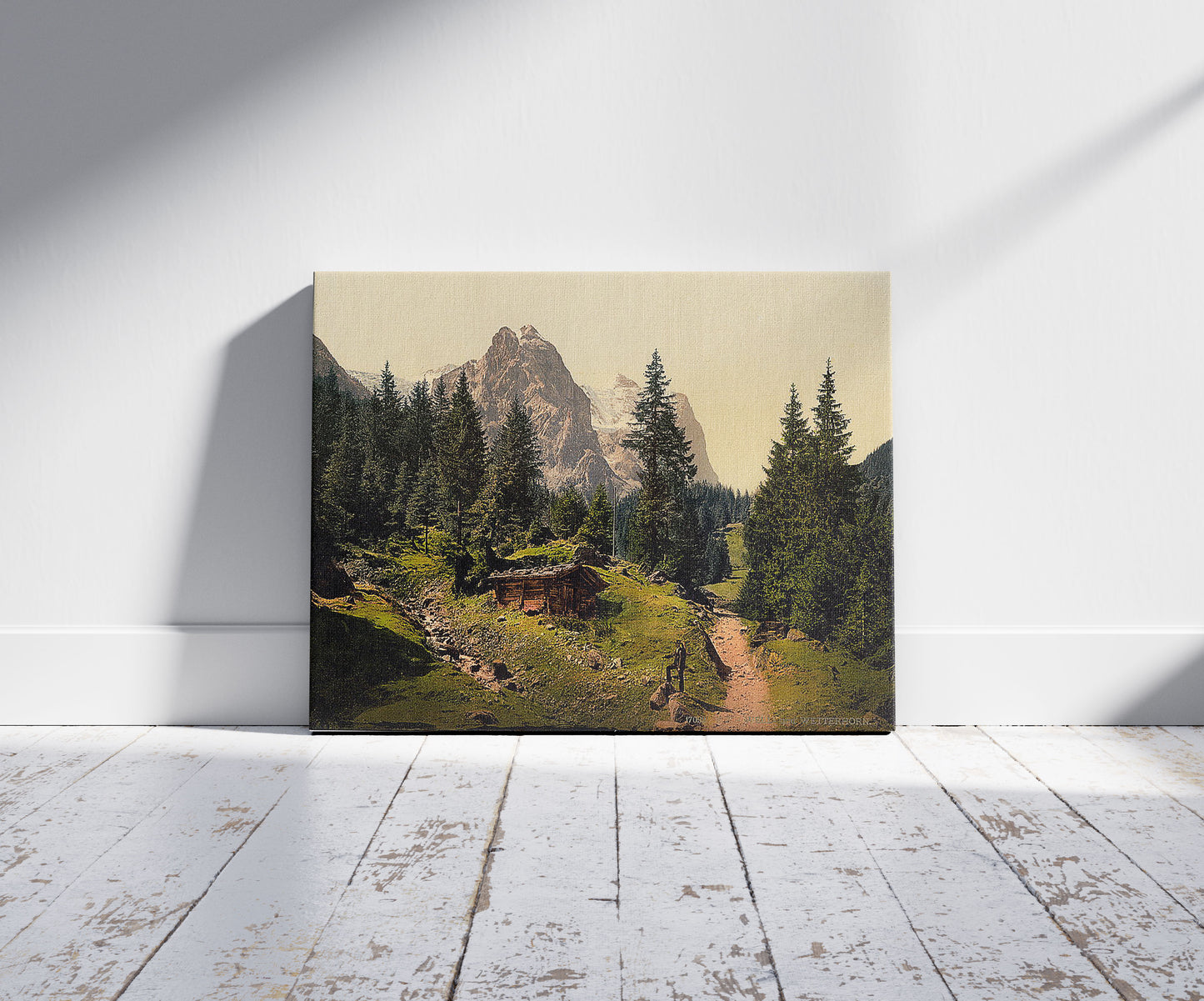 A picture of Well and Wetterhorn Mountains, Bernese Oberland, Switzerland, a mockup of the print leaning against a wall