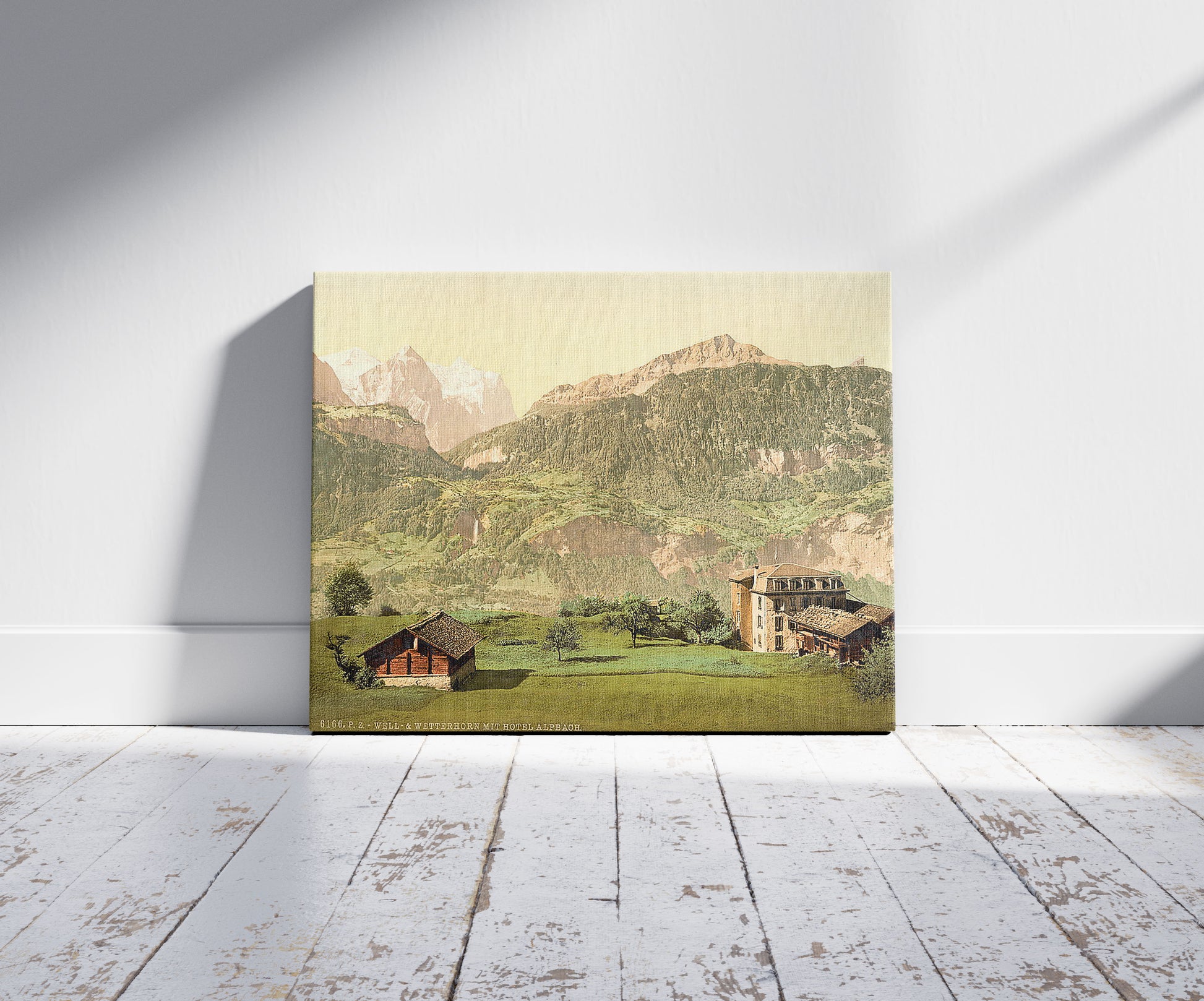 A picture of Well and Wetterhorn, with Hotel Alpbach, Bernese Oberland, Switzerland, a mockup of the print leaning against a wall