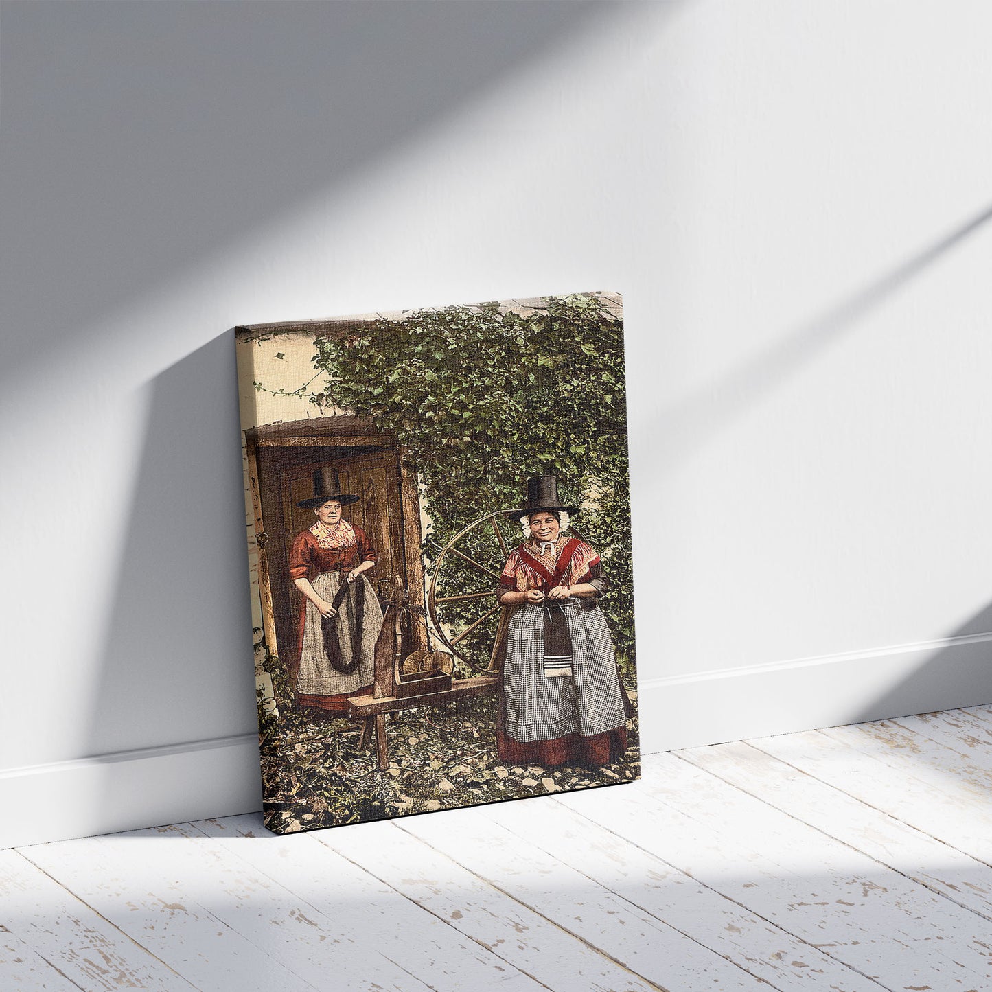 A picture of Welsh spinners and spinning wheel, Wales, a mockup of the print leaning against a wall