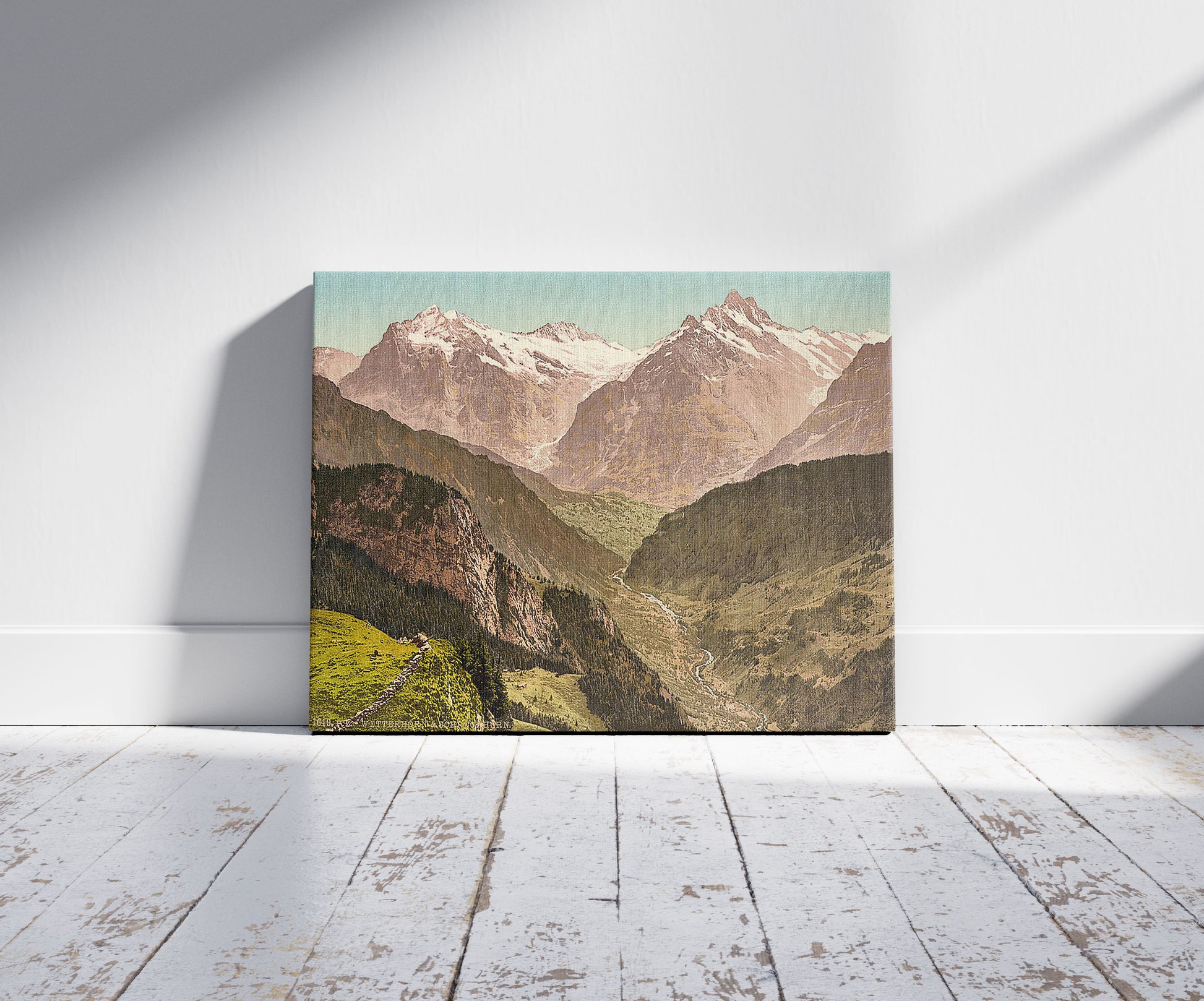 A picture of Wetterhorn and Schreckhorn, from Schynige Platte, Bernese Oberland, Switzerland, a mockup of the print leaning against a wall