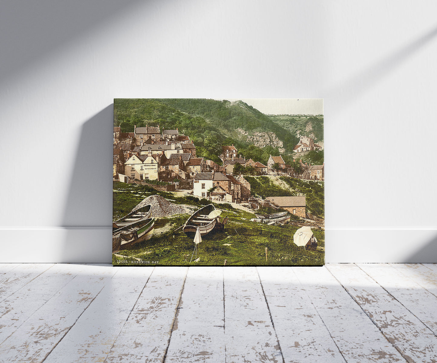 A picture of Whitby, Runswick Bay, Yorkshire, England, a mockup of the print leaning against a wall