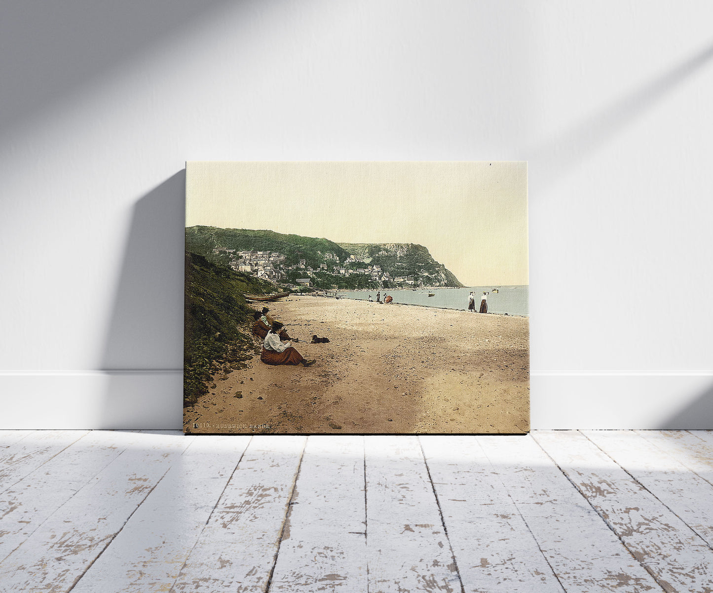 A picture of Whitby, Runswick sands, Yorkshire, England, a mockup of the print leaning against a wall