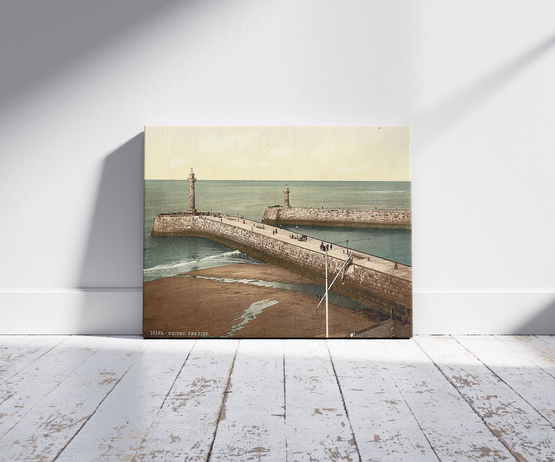 A picture of Whitby, the pier, Yorkshire, England, a mockup of the print leaning against a wall