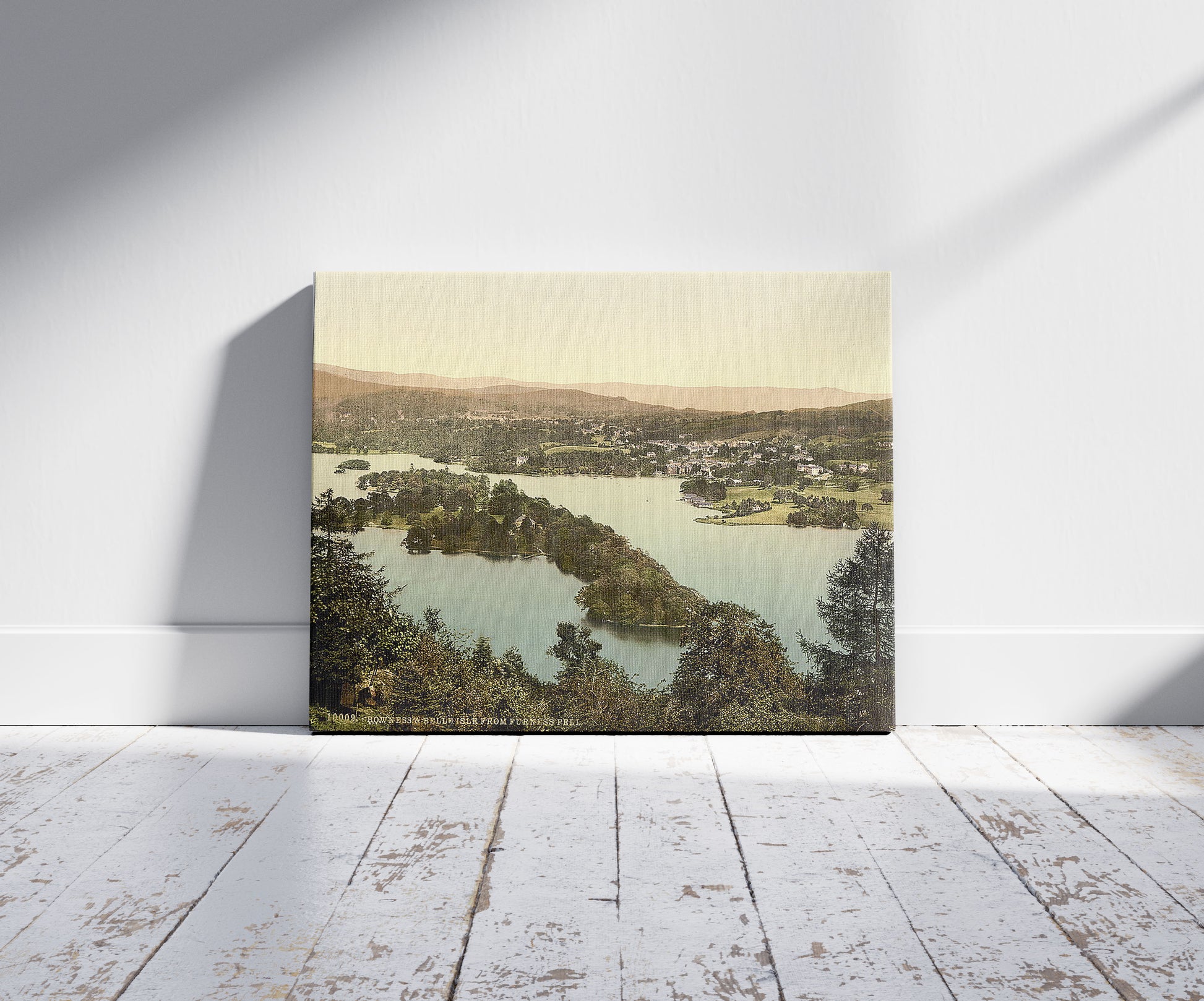 A picture of Windermere and Bowness, Lake District, England, a mockup of the print leaning against a wall