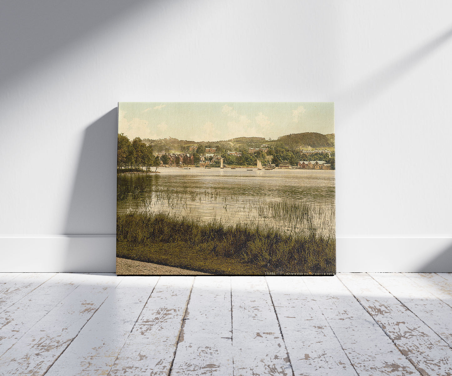 A picture of Windermere, Bowness, from Bellisle, Lake District, England, a mockup of the print leaning against a wall