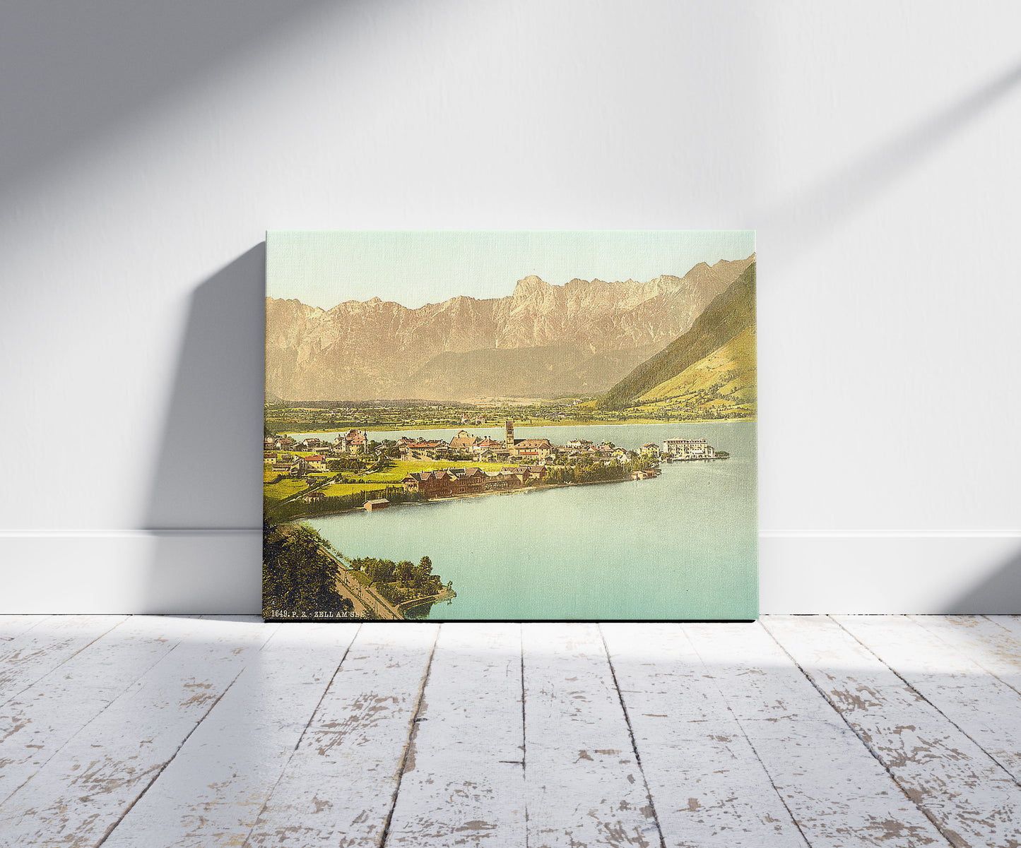 A picture of Zell on the lake (i.e., Zell am See) from the Steinernes Meer, Austria, Austro-Hungary, a mockup of the print leaning against a wall