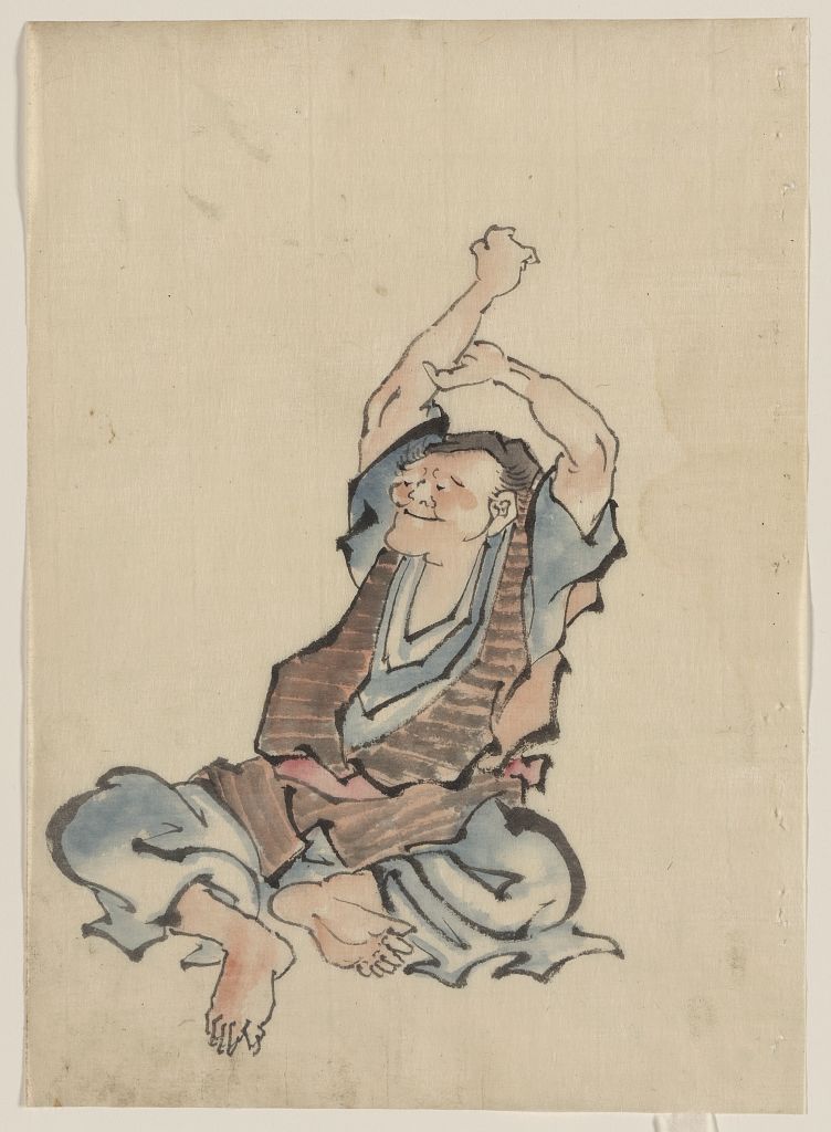 A picture of A man, facing left, wearing several layers of clothing, sitting with arms raised over his head, practicing yoga