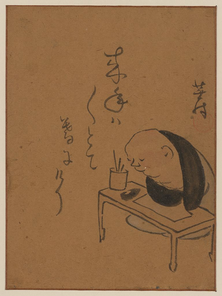 A picture of A man or monk seated at a table, leaning on his arms, possibly asleep or meditating