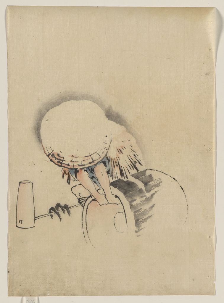 A picture of A man, wearing a large conical hat and a straw or feather garment, attempting to turn on end a barrel-like object, possibly a mochi tub; on the ground next to him is long-handled mallet
