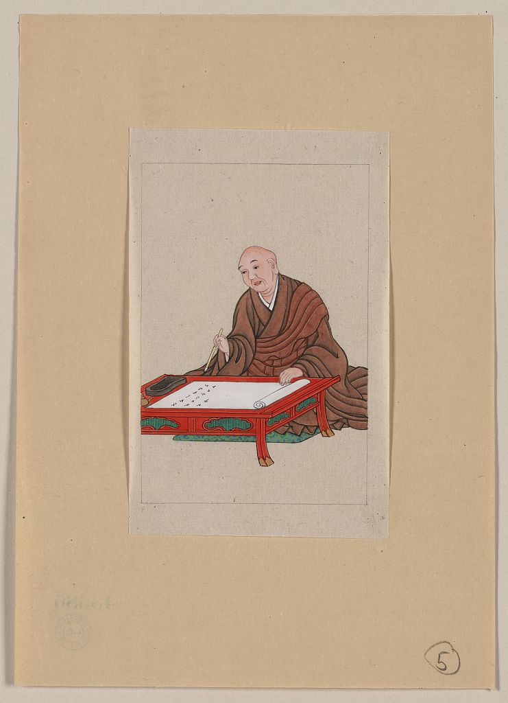 A picture of An old man, possibly a monk or scholar, seated a low table writing on scroll with brush