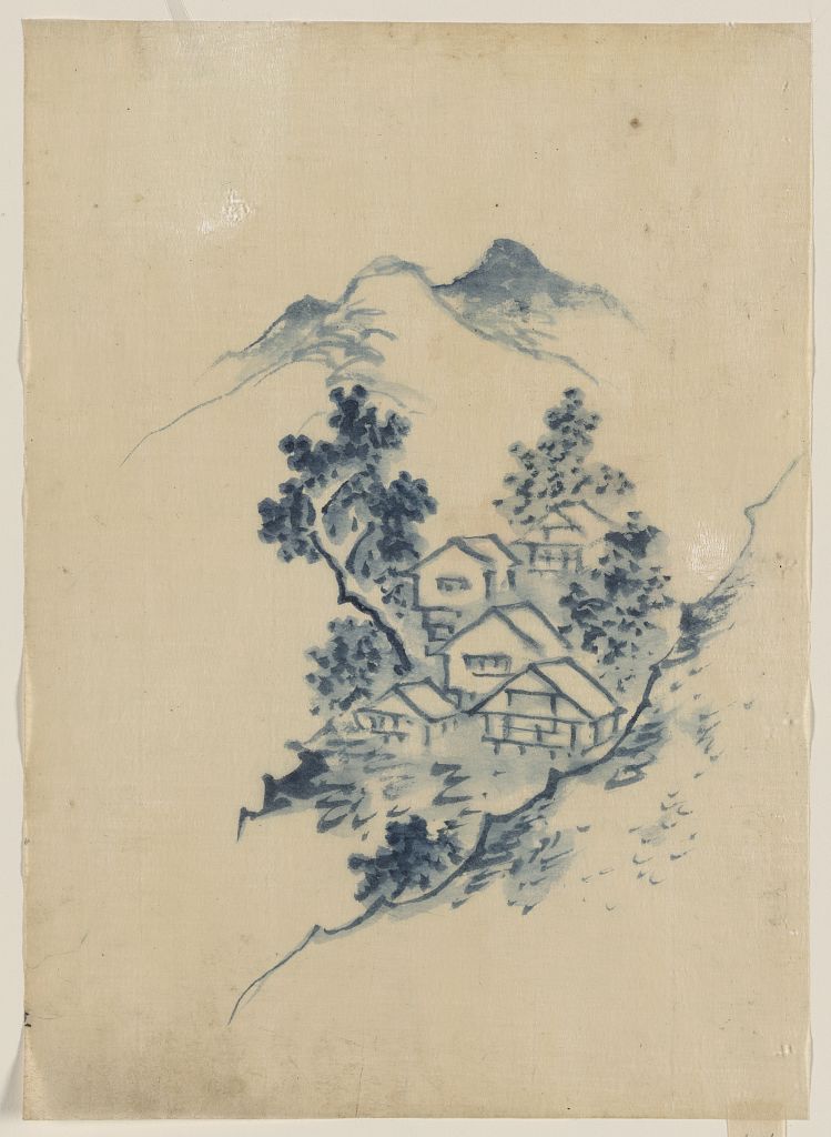 A picture of Buildings nestled among trees in a mountain valley